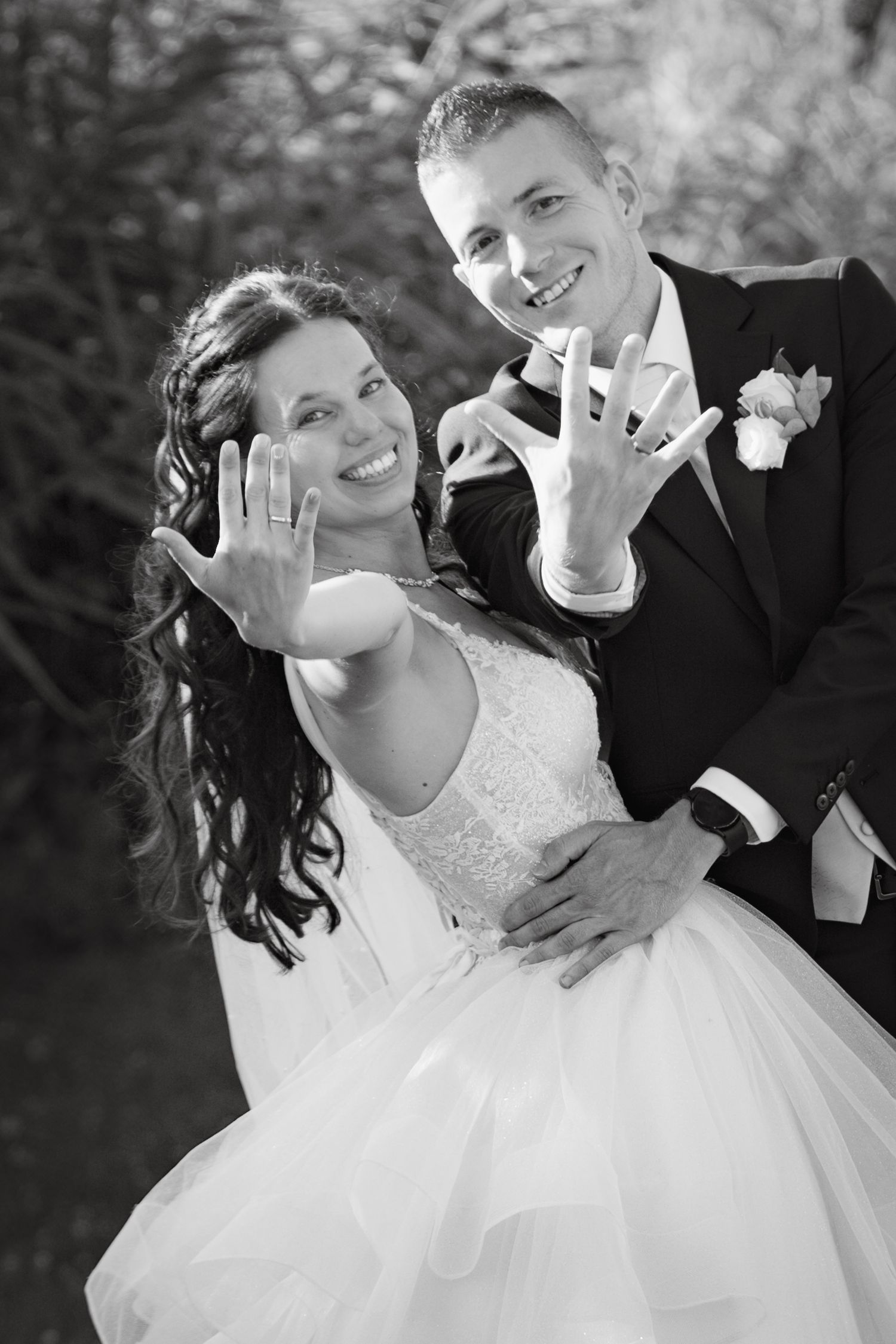 Black and white wedding portraits showing joyful expressions and rings.