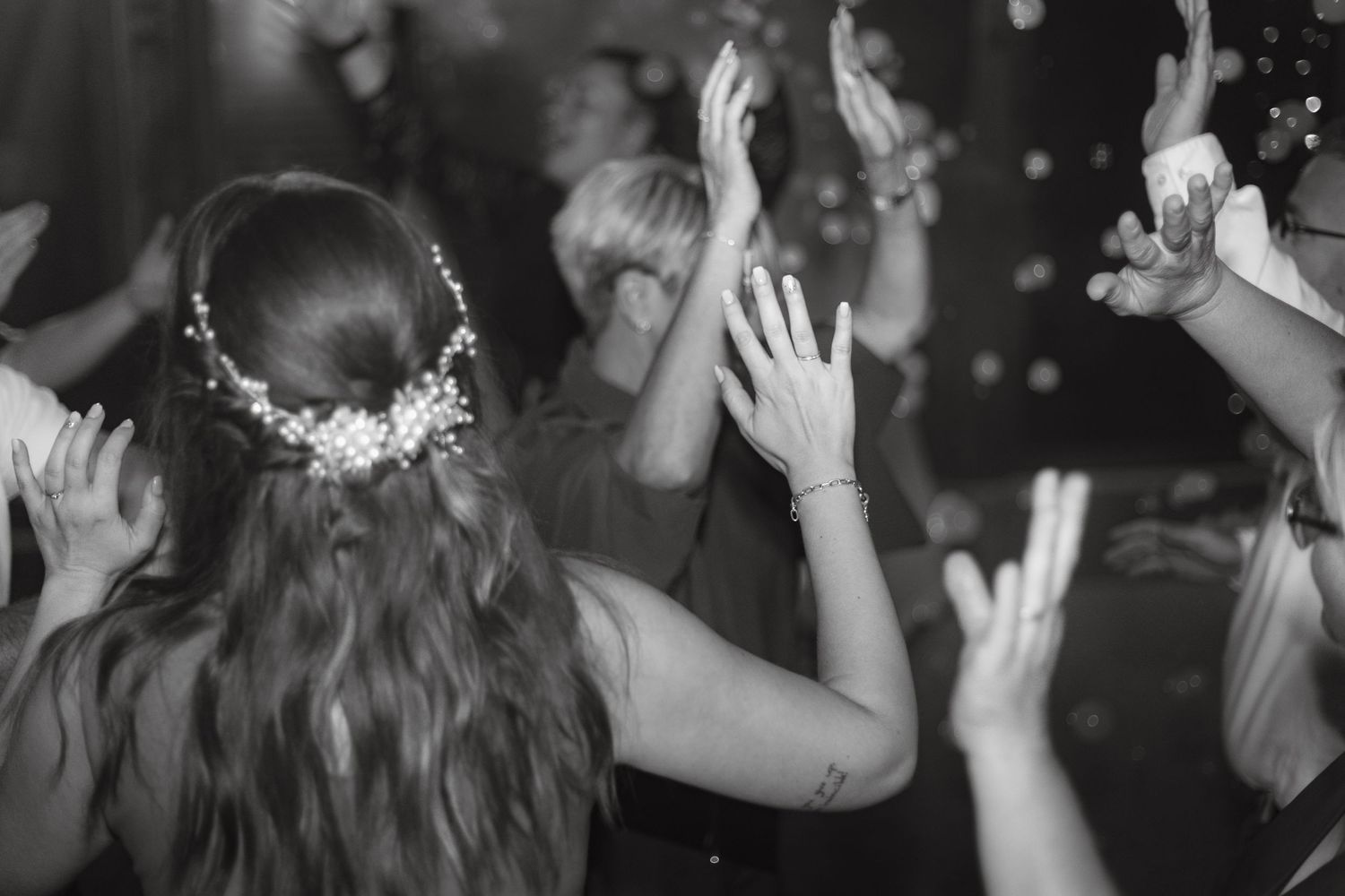 Guests dancing and celebrating at a lively wedding reception party.