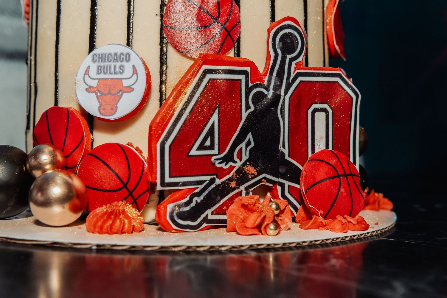 Chicago Bulls themed 40th birthday cake with Air Jordan logo, basketballs, and orange decorations.