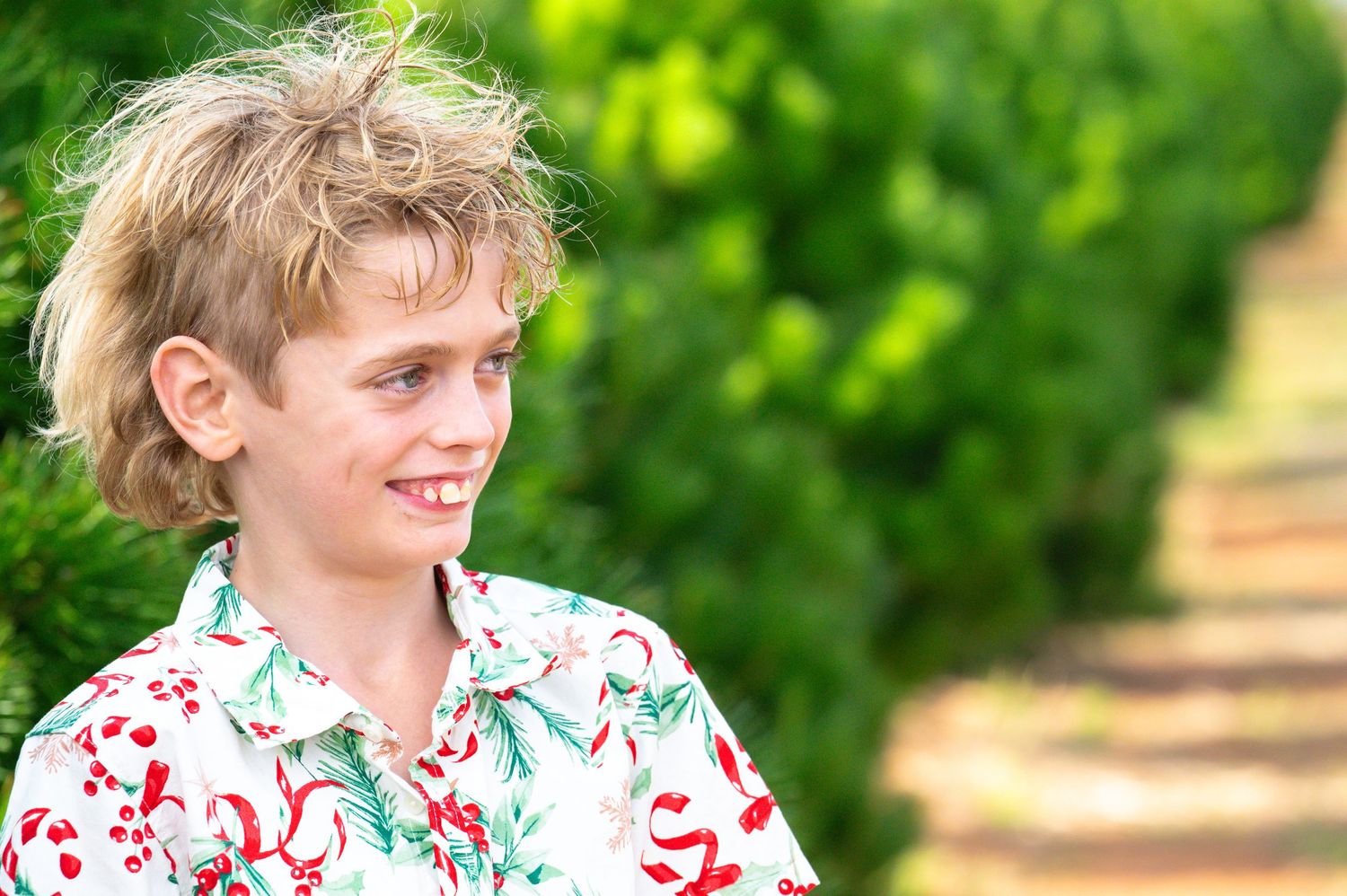 Natural light portrait session with matching floral shirts in a garden setting.