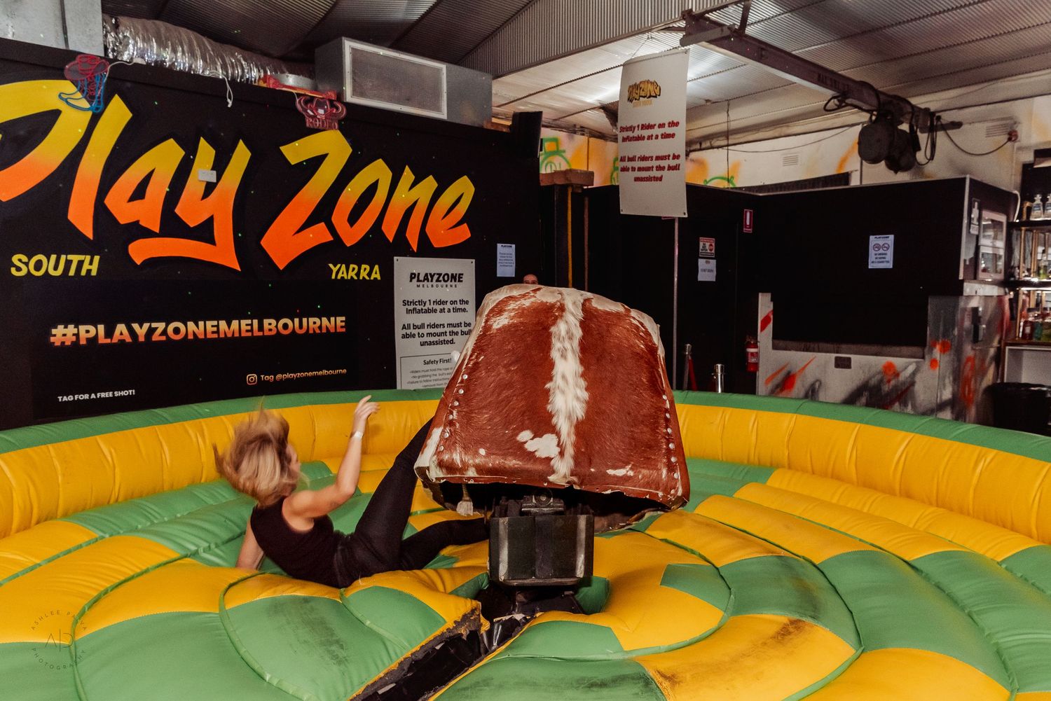 Person riding a mechanical bull at Play Zone South Yarra Melbourne indoor entertainment venue.