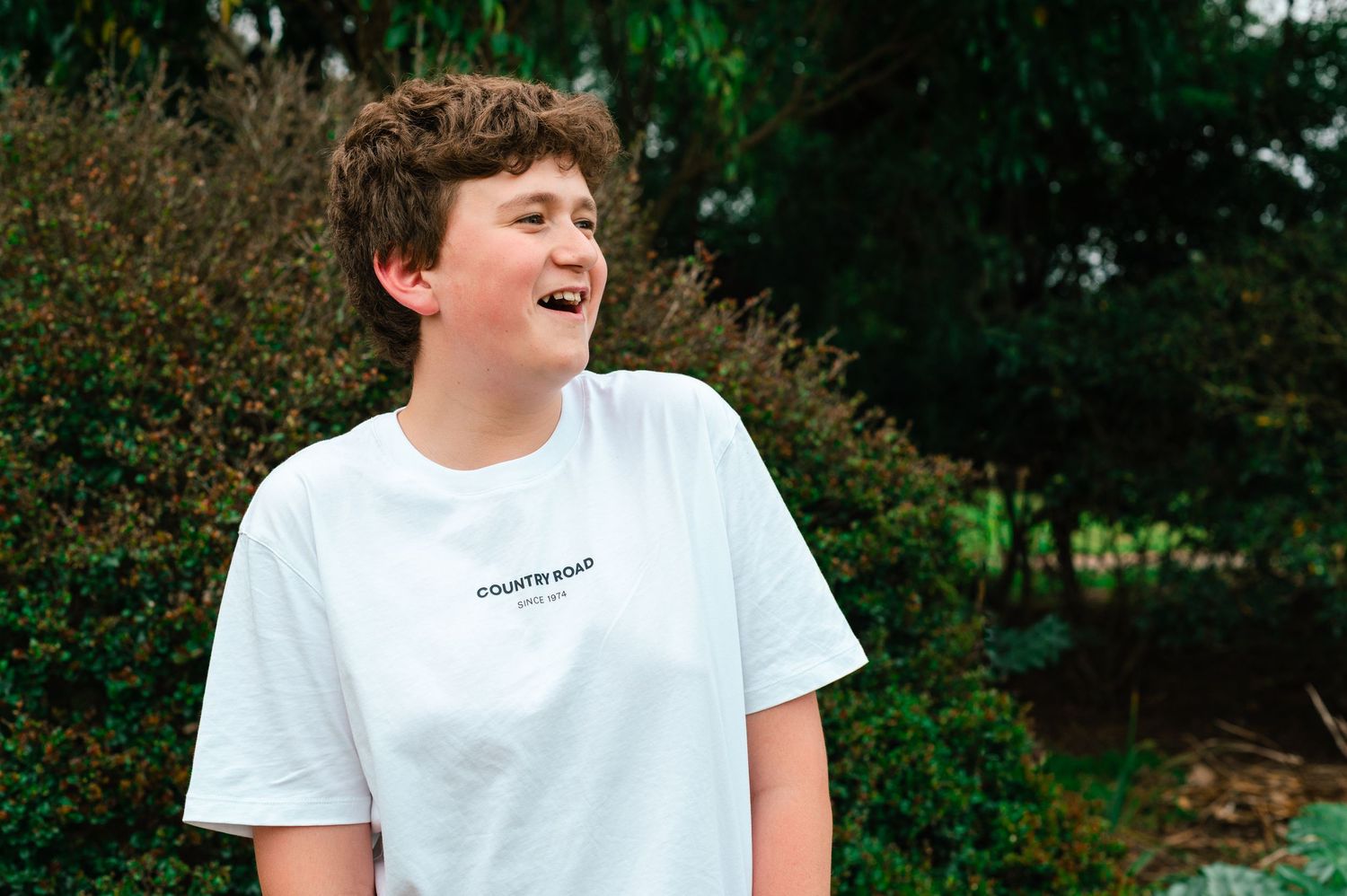 Natural and candid expressions during an outdoor summer photoshoot.