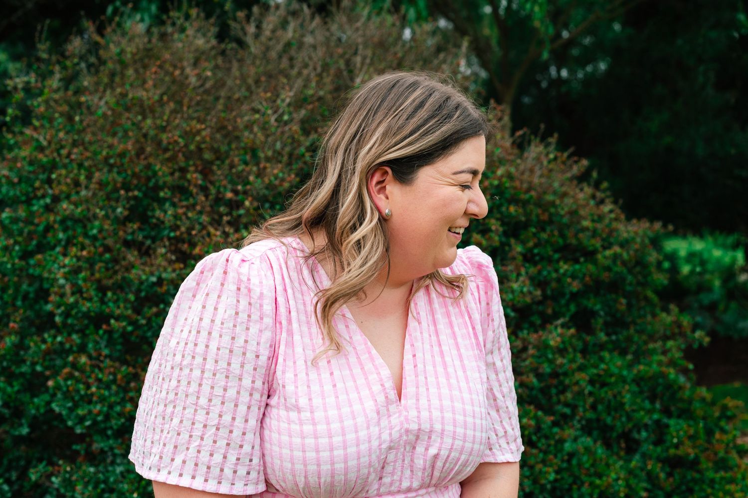 Casual outdoor portrait session featuring pink gingham dress and white t-shirt.