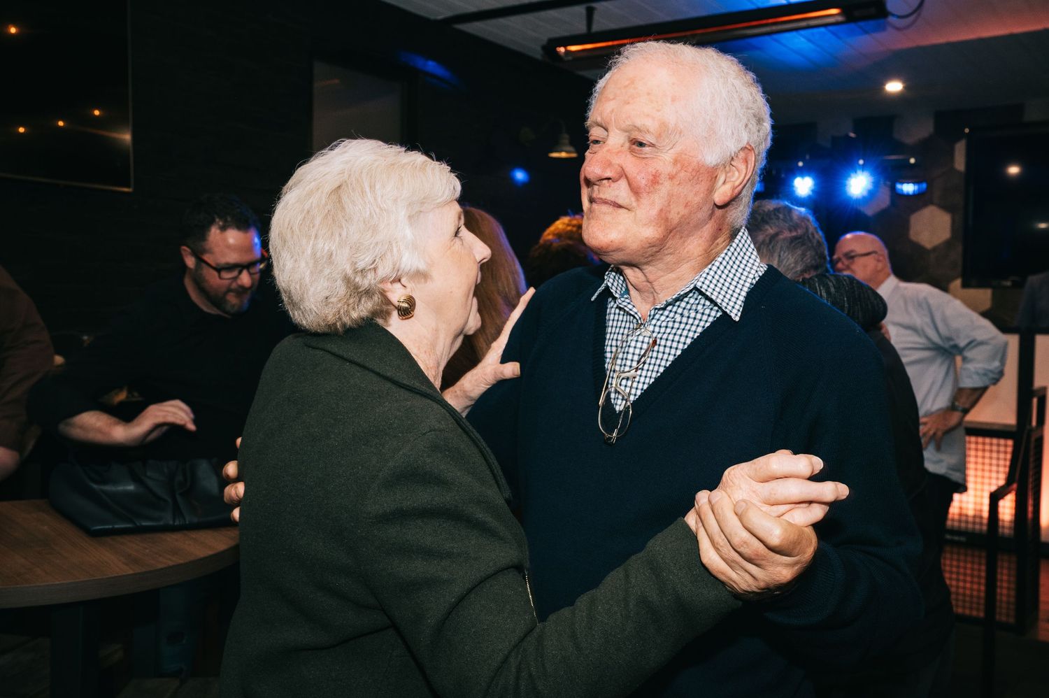 Senior couple dancing together at an evening celebration.