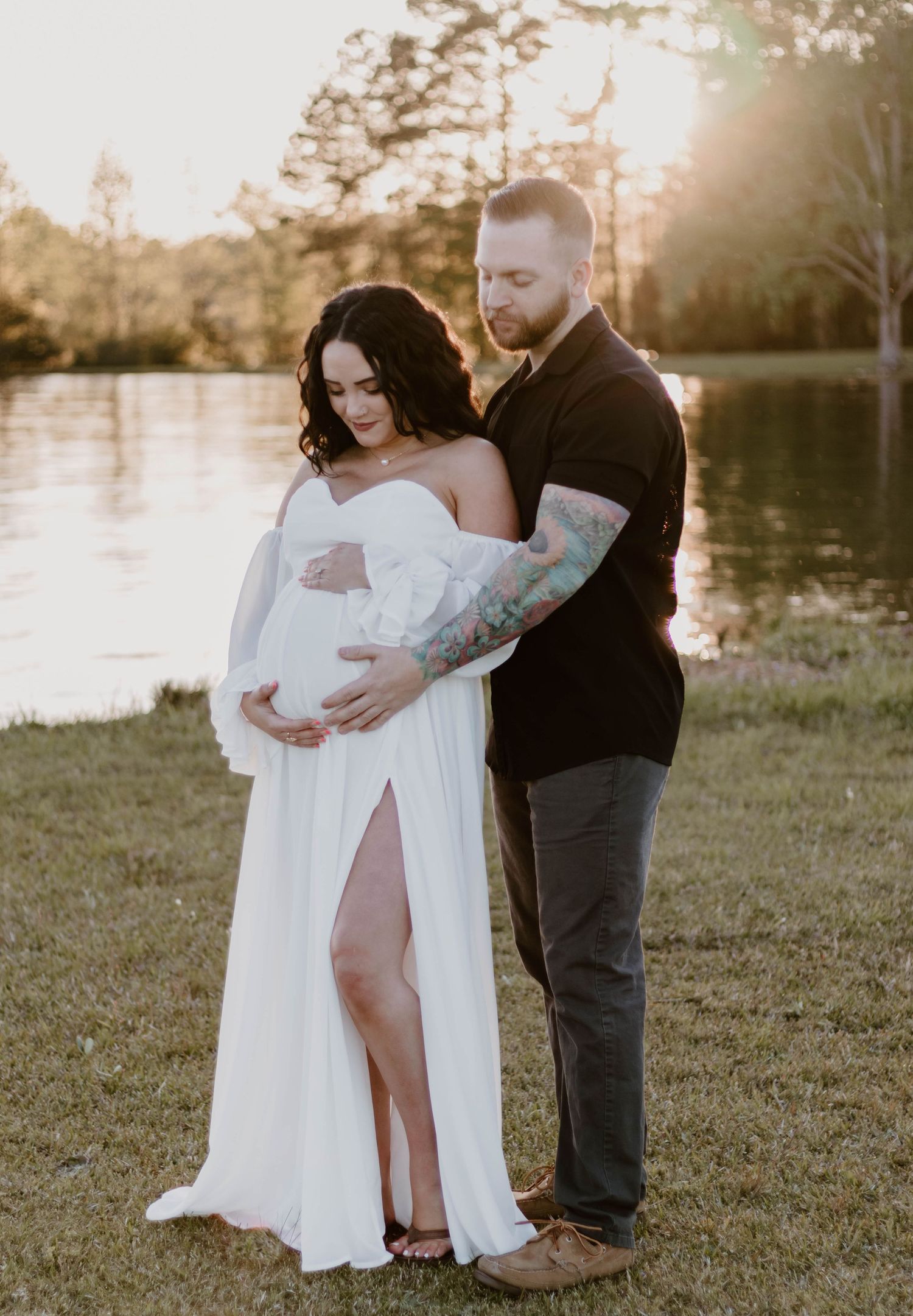 A romantic couple's portrait session by a lake at sunset.