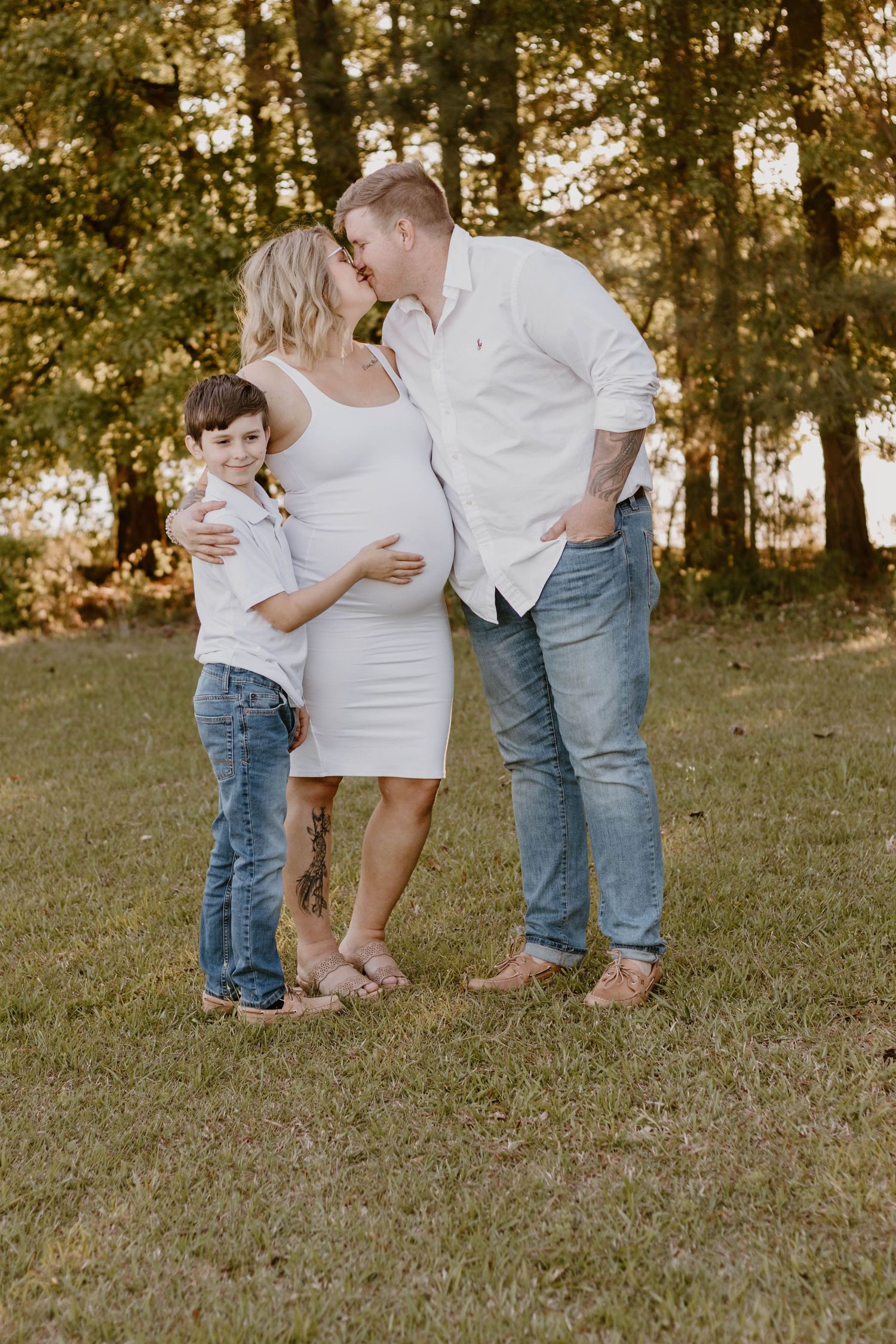 Intimate family portrait showing tender moment in outdoor setting.