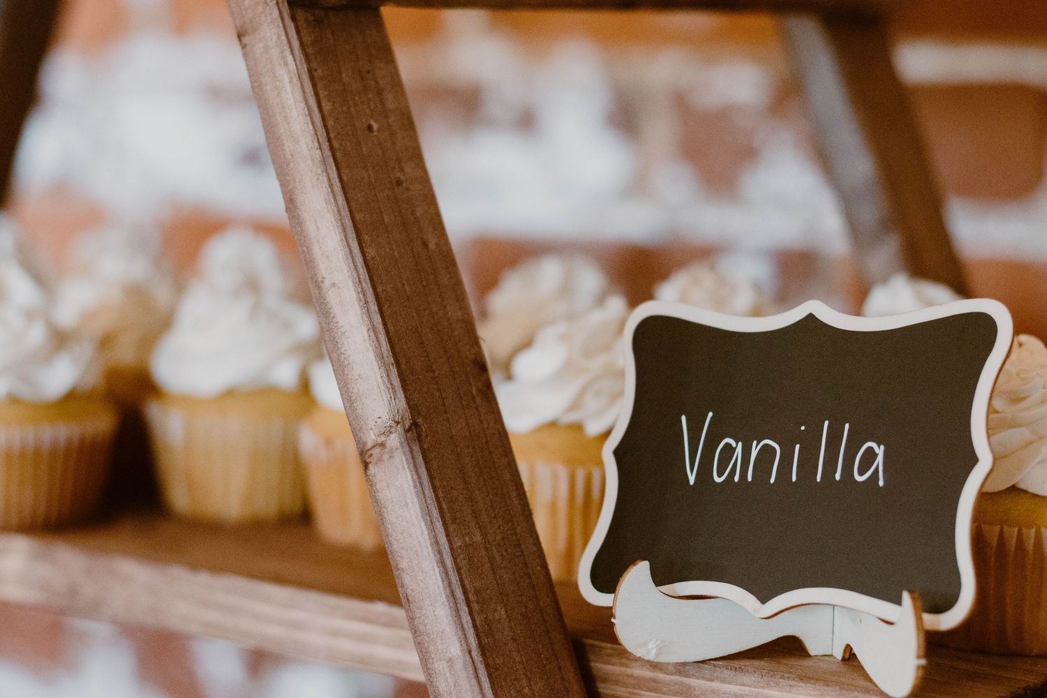 Rustic chalkboard signs displayed at wedding dessert table.