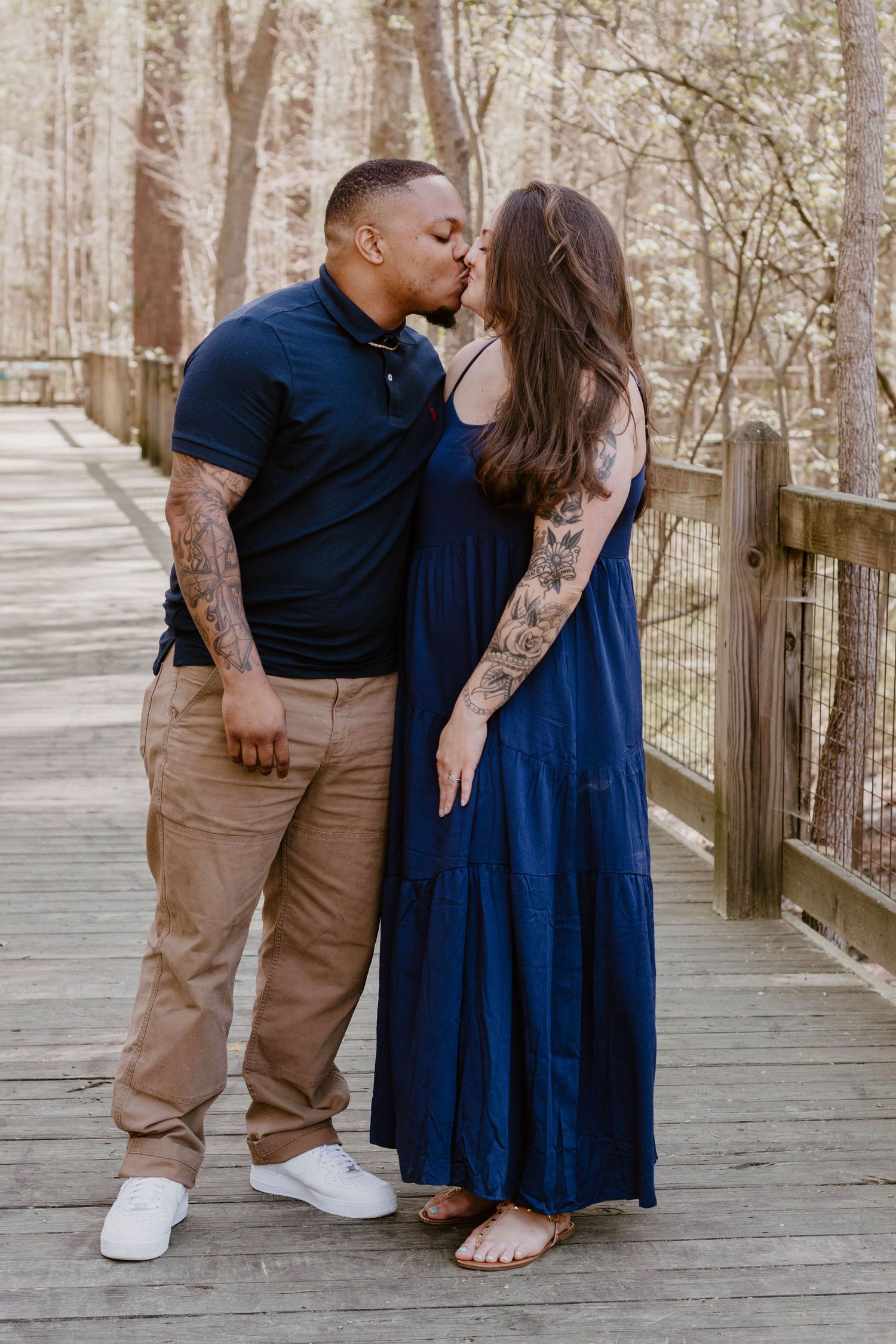 Intimate family photos taken on a wooden boardwalk showing loving interactions.