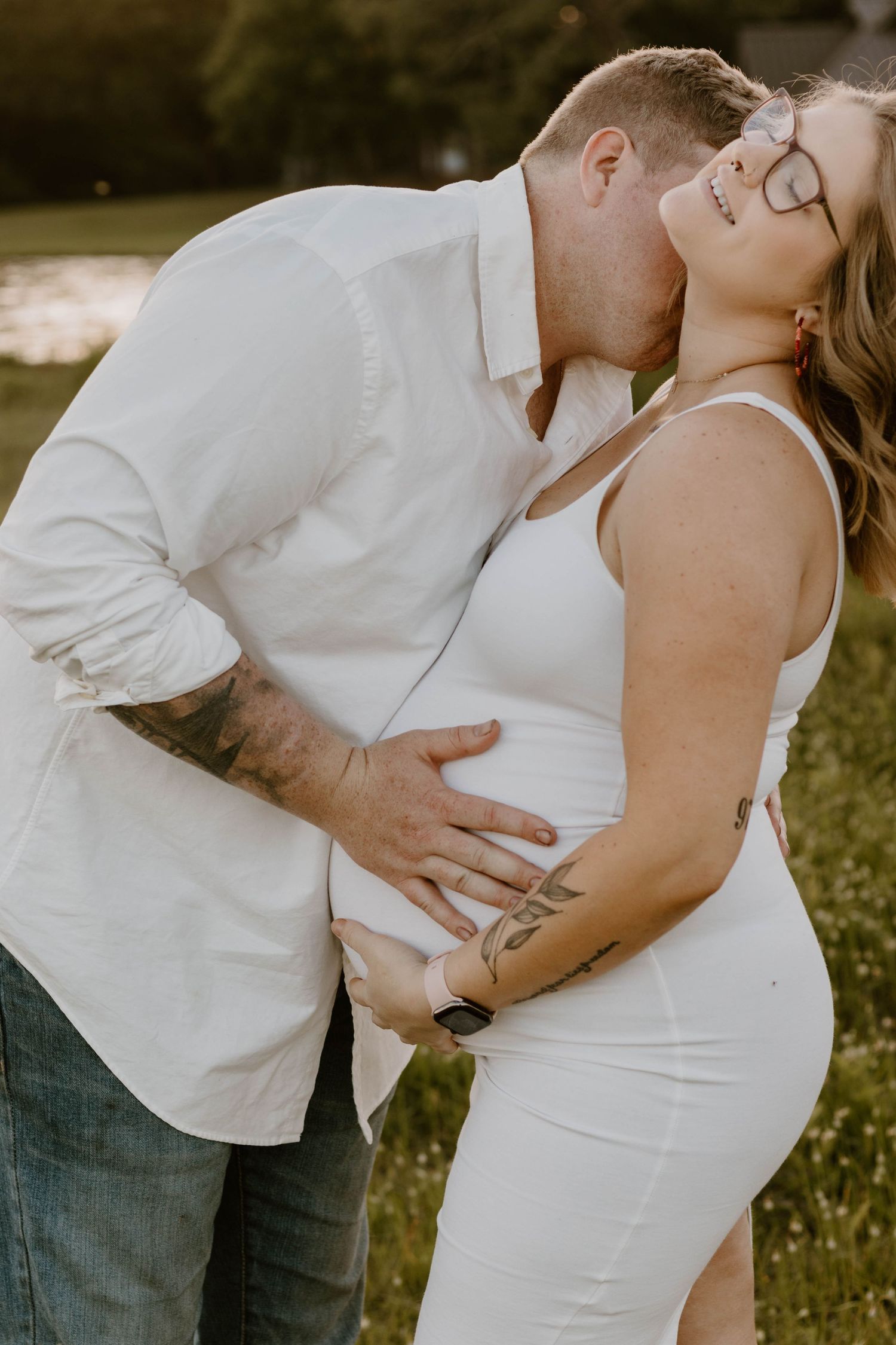 A romantic moment captured between a couple during their outdoor maternity session.