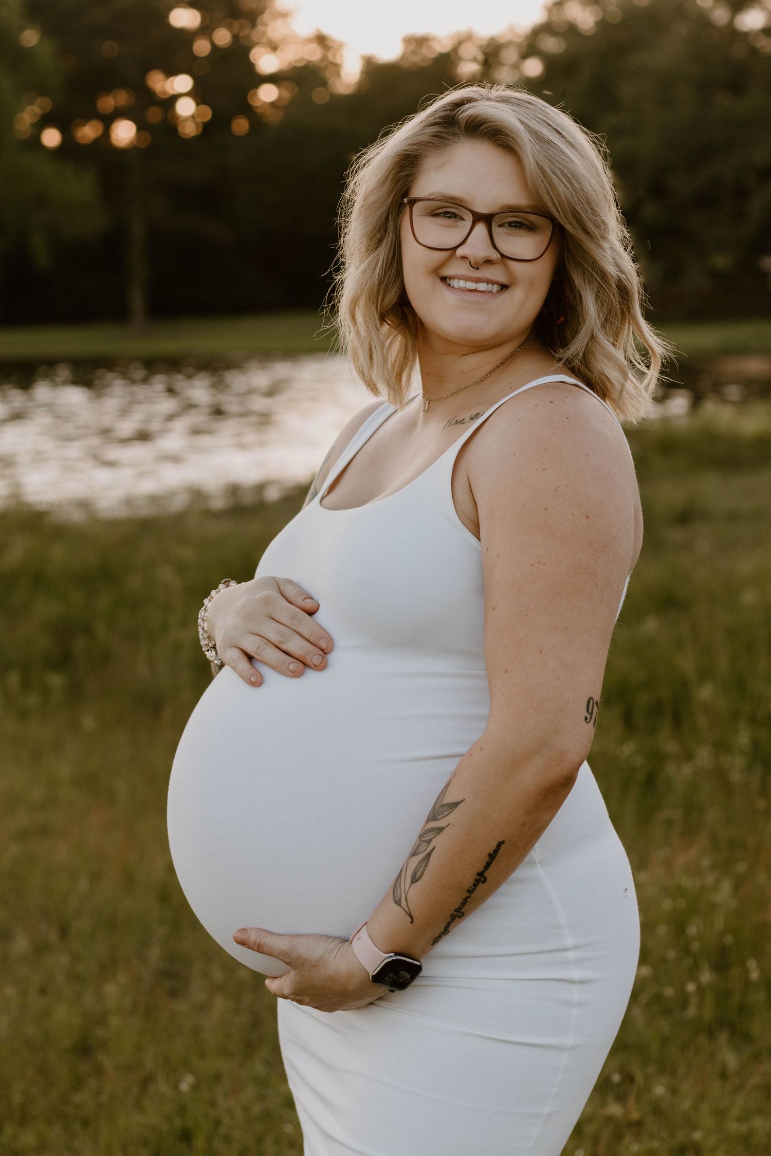 Side view maternity portraits showing pregnancy silhouette at golden hour.