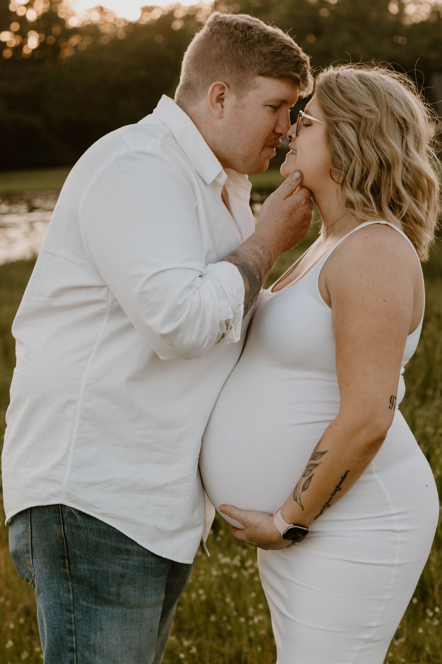 An intimate portrait of a couple sharing a tender moment during their maternity photoshoot.