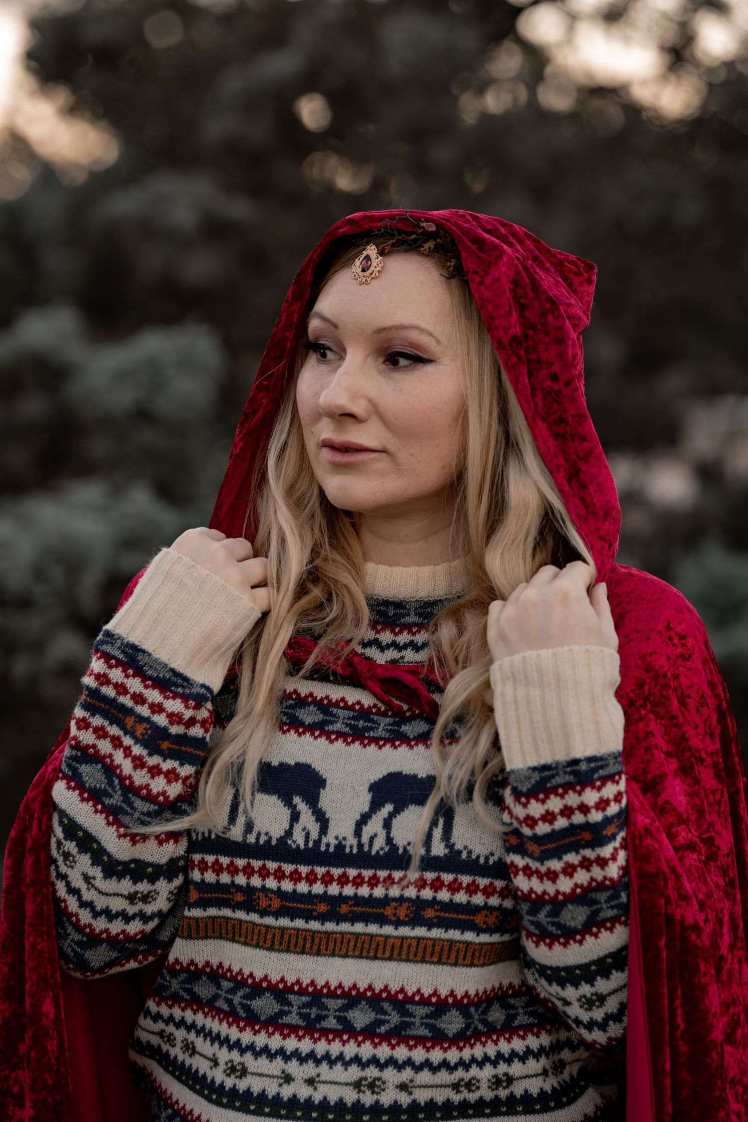 Winter fashion portrait featuring a cozy Nordic patterned sweater and red knit accessory.
