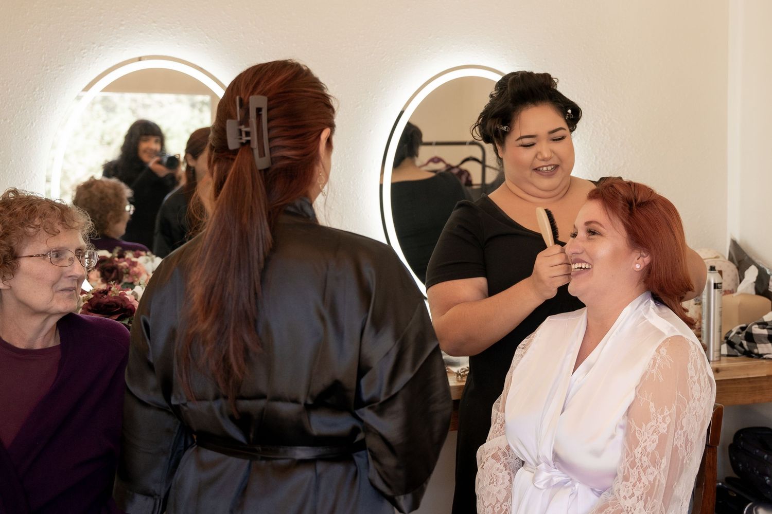 Bride to be gets ready surrounded by friends.