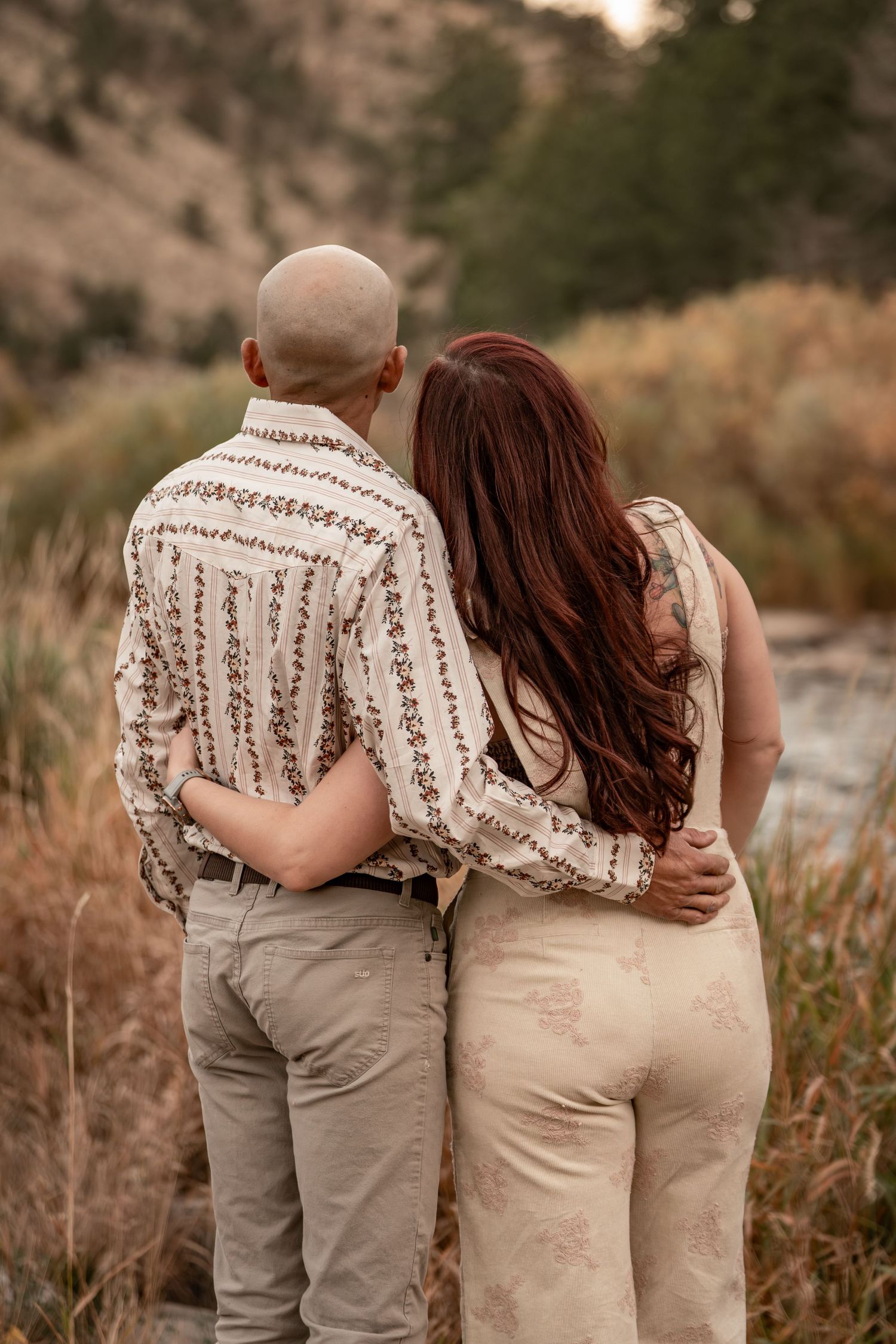 Intimate moments captured in a series of romantic poses against a natural mountain setting.