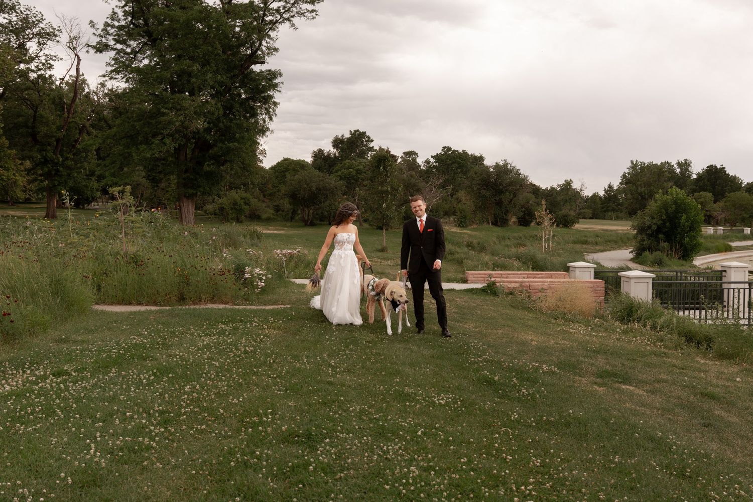 Scenic wedding photography session in a rustic outdoor setting with rolling hills and natural greenery.