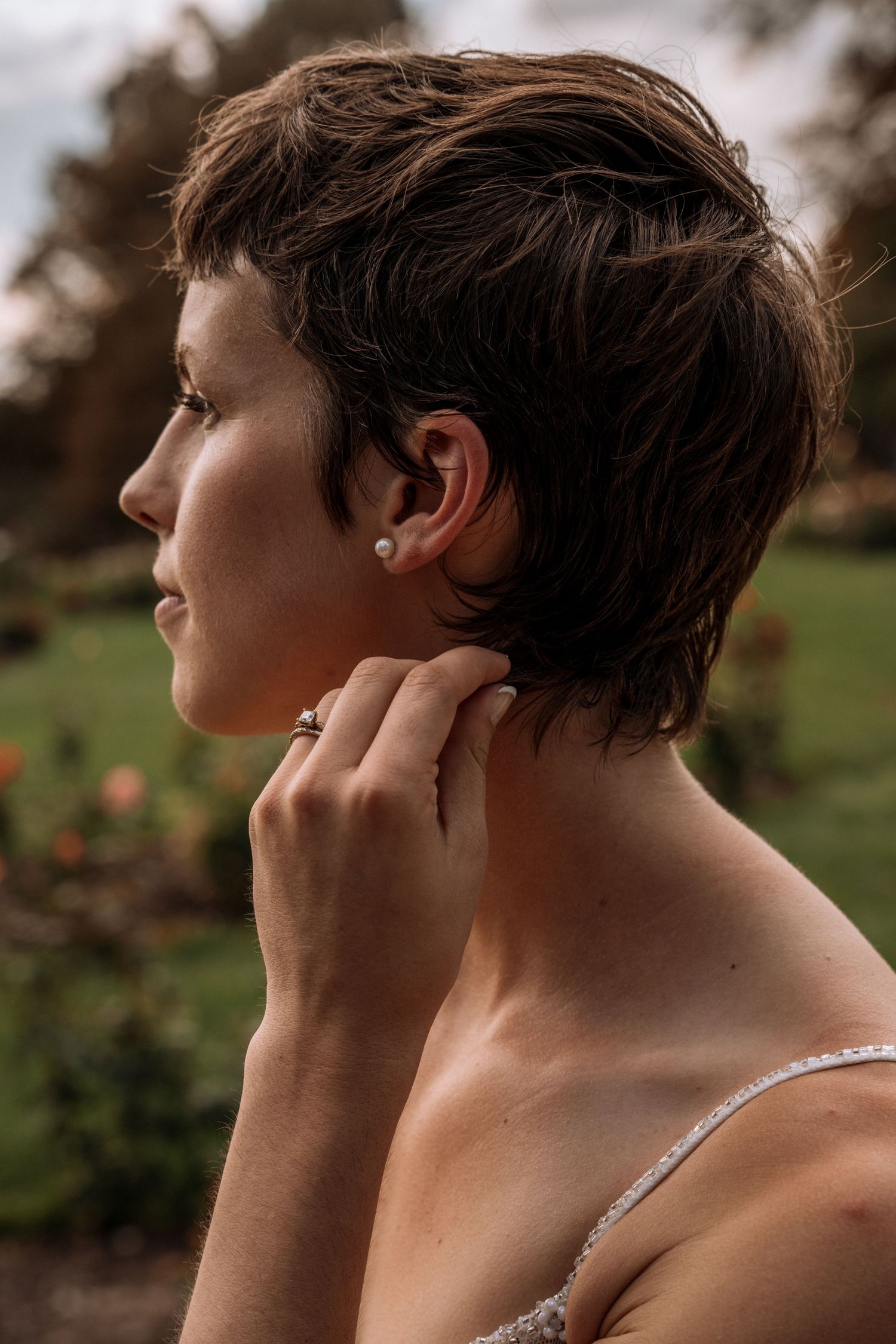 Side profile views showing a person's head and neck against a blurred outdoor background in warm lighting.
