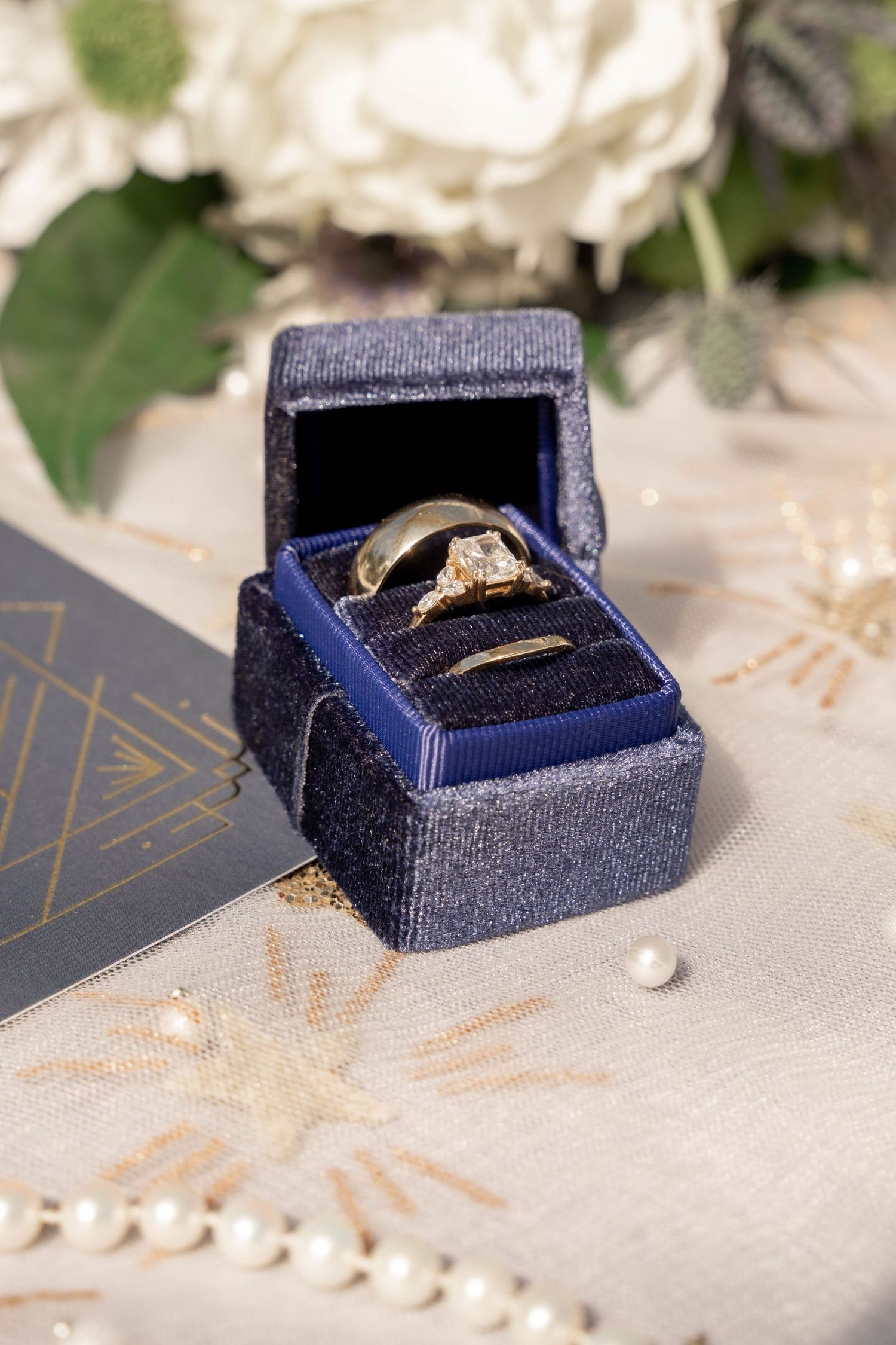 A sequence of photos showing a navy blue velvet ring box with a diamond engagement ring from different angles.