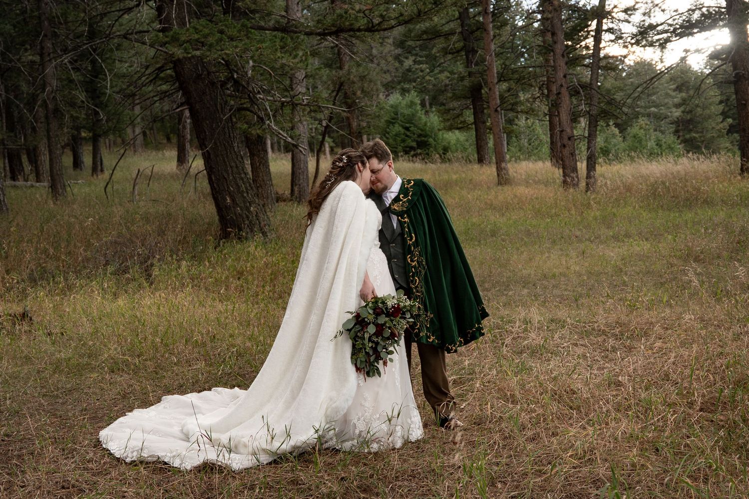 Wedding couple poses in various romantic shots among pine trees in a forest setting.