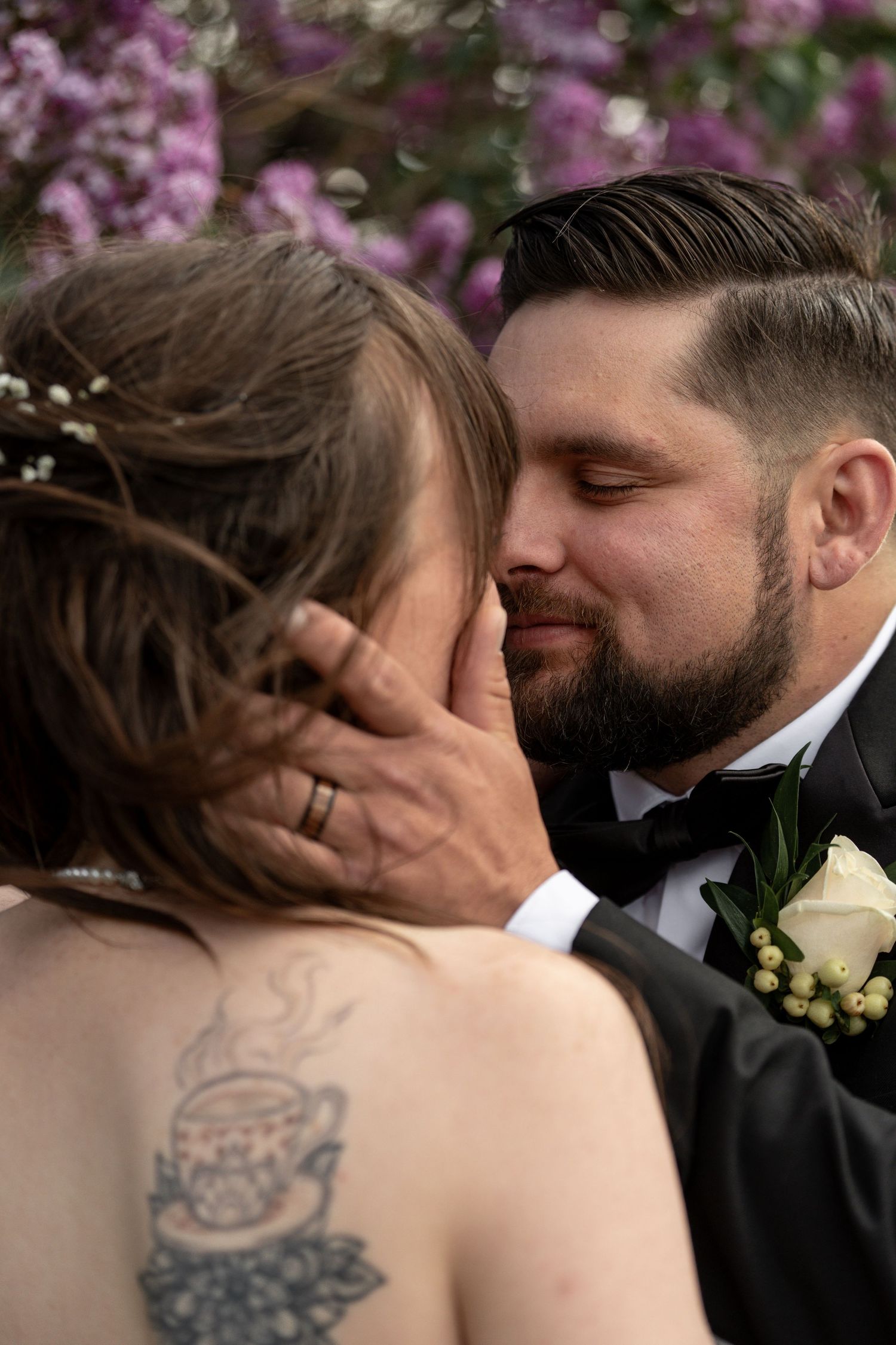Intimate wedding portraits with cherry blossoms in background.