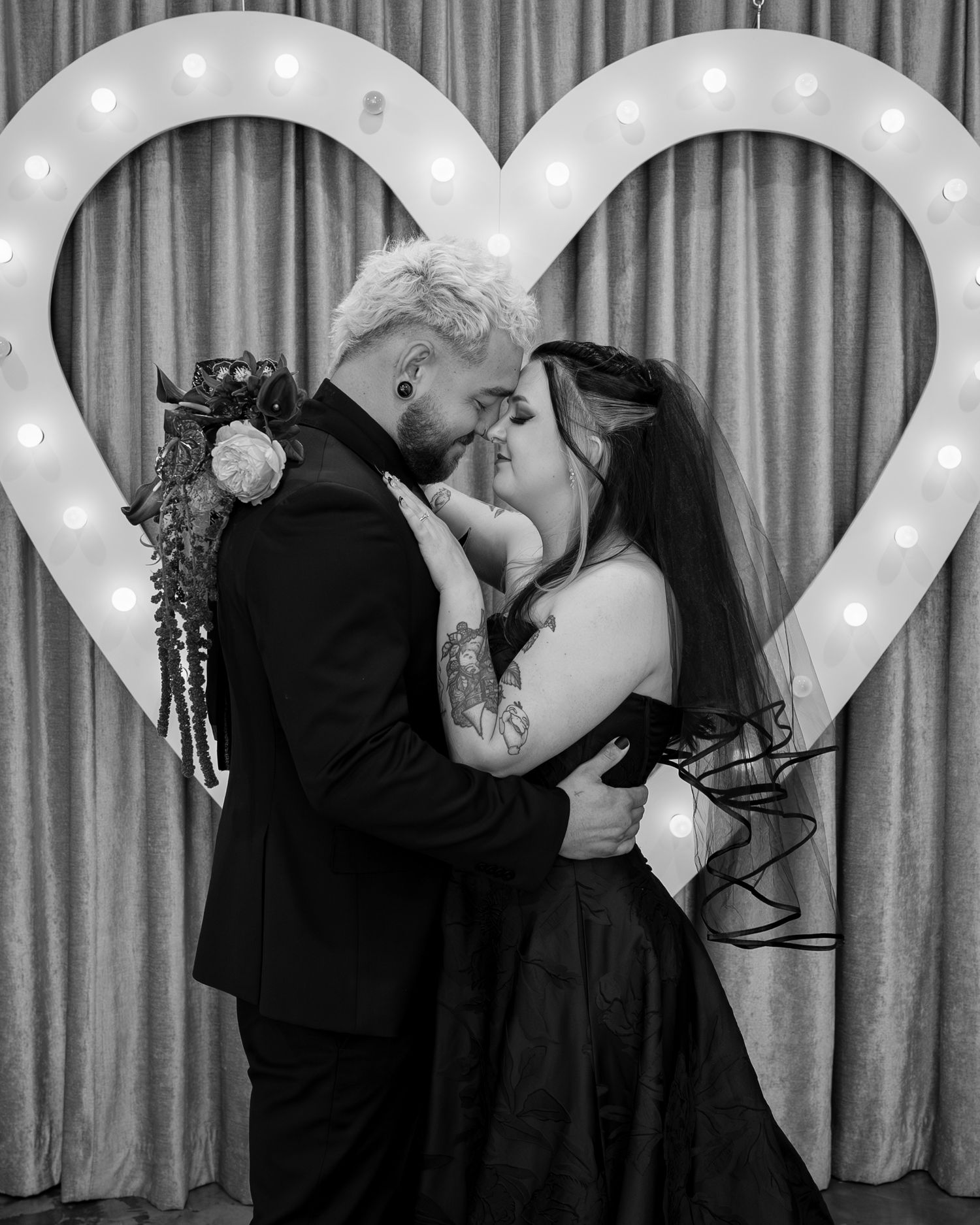 Romantic sequence of a couple under illuminated marquee lights.