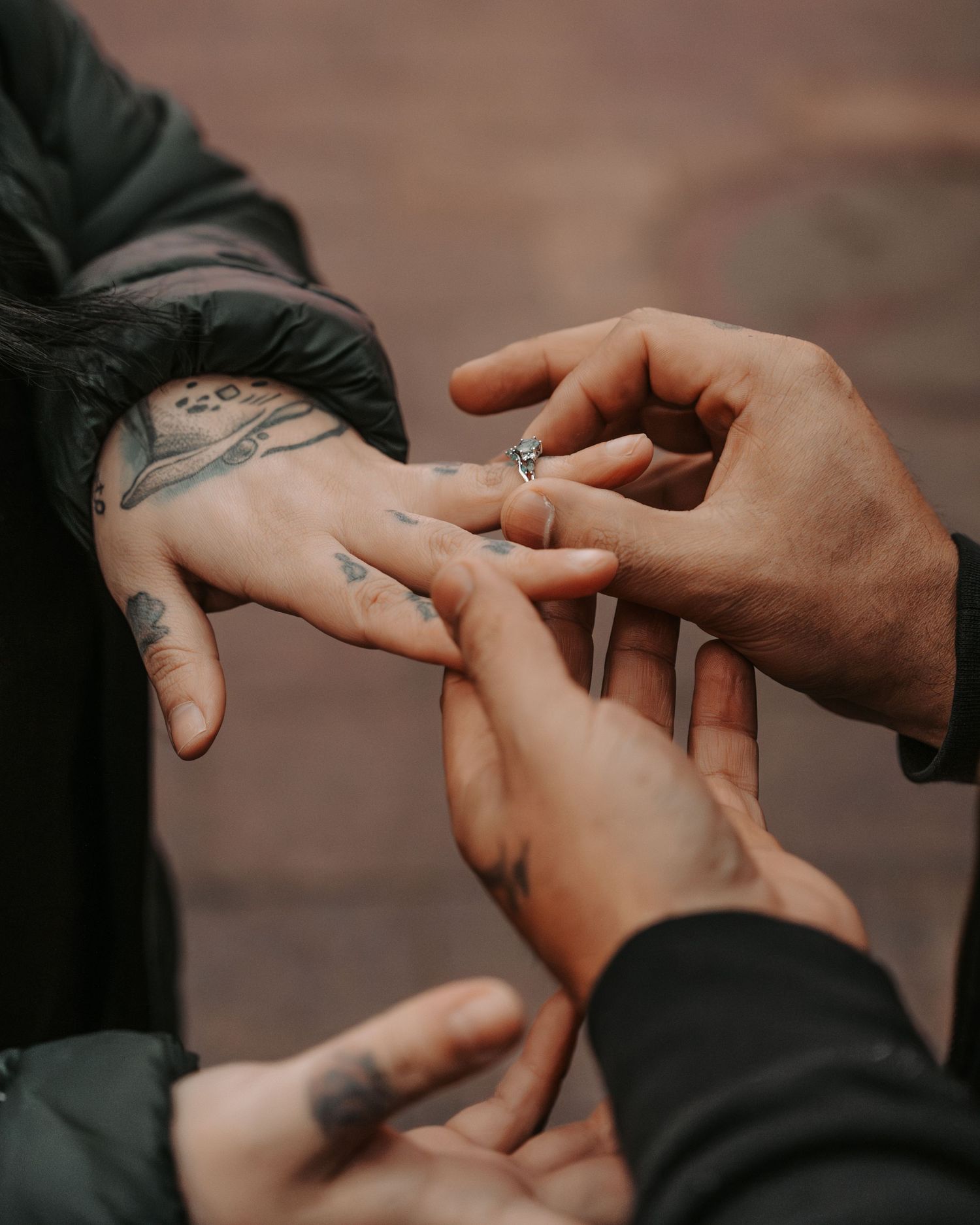 Close-up of hands exchanging rings during a special moment.