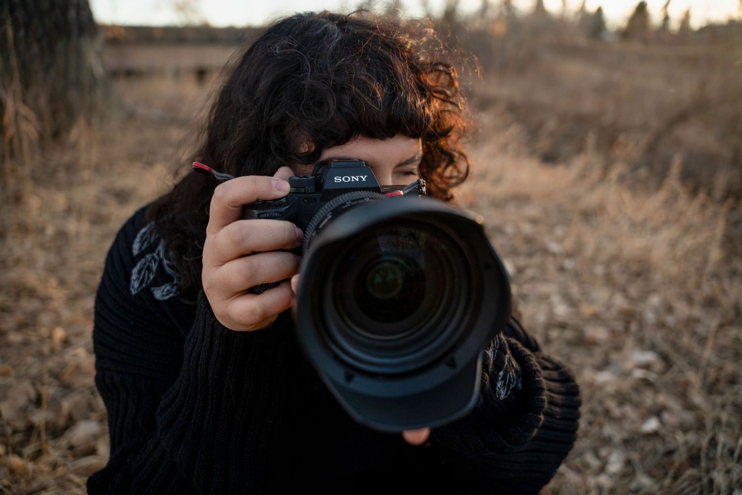 A series of six photos showing someone holding a camera while taking photos in a brown outdoor field.