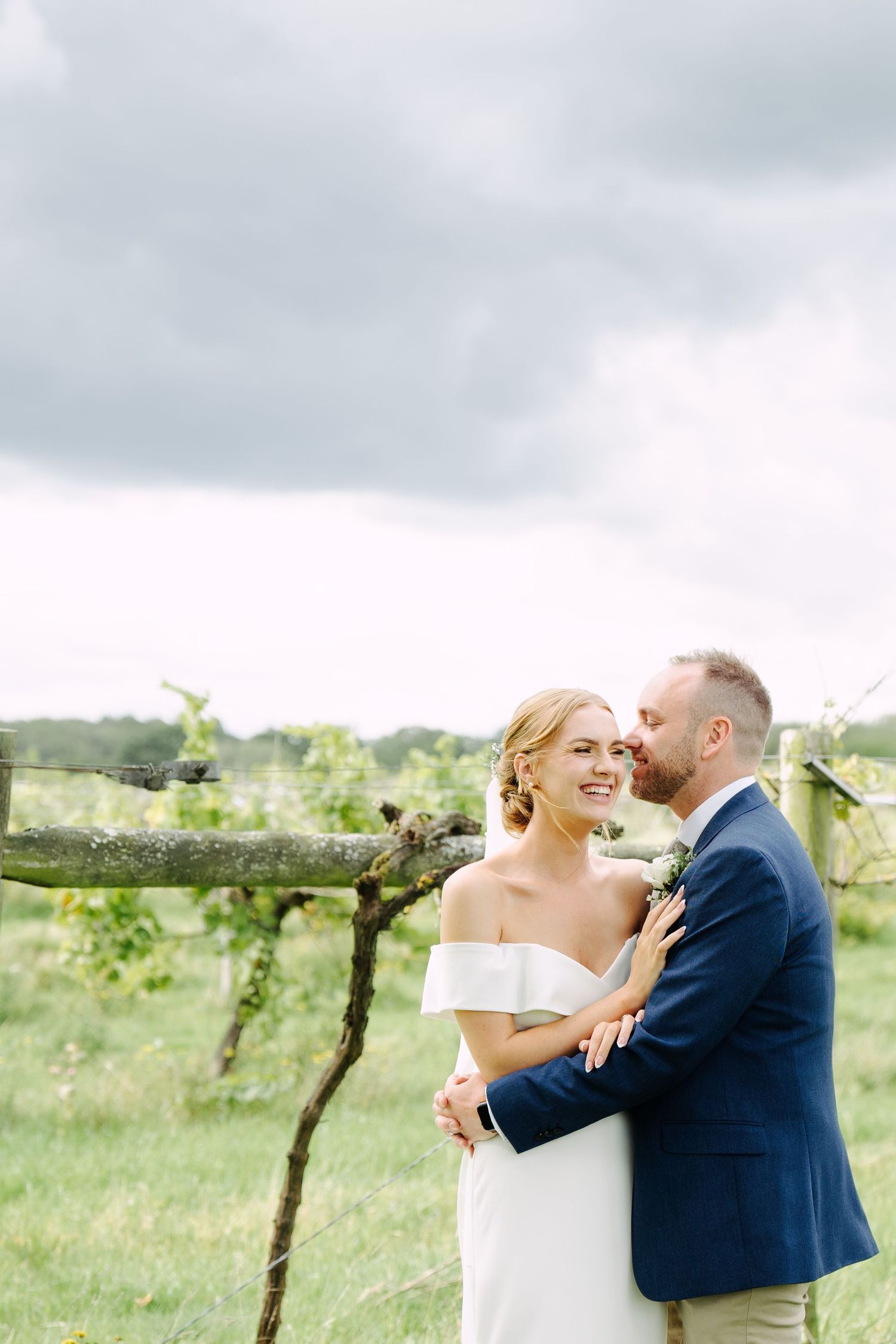 Cheeky whisper in the ear of the Bride form the Groom, something to make her laugh, allowing the photographer to capture the real moment