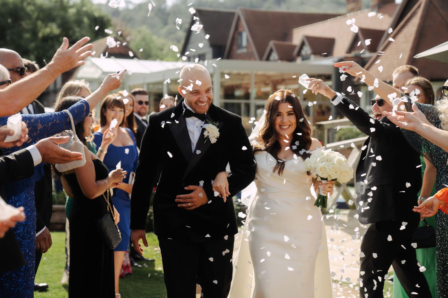 A exciting moment shared with the wedding party as the bride and groom walk down the isle with confetti flying everywhere.