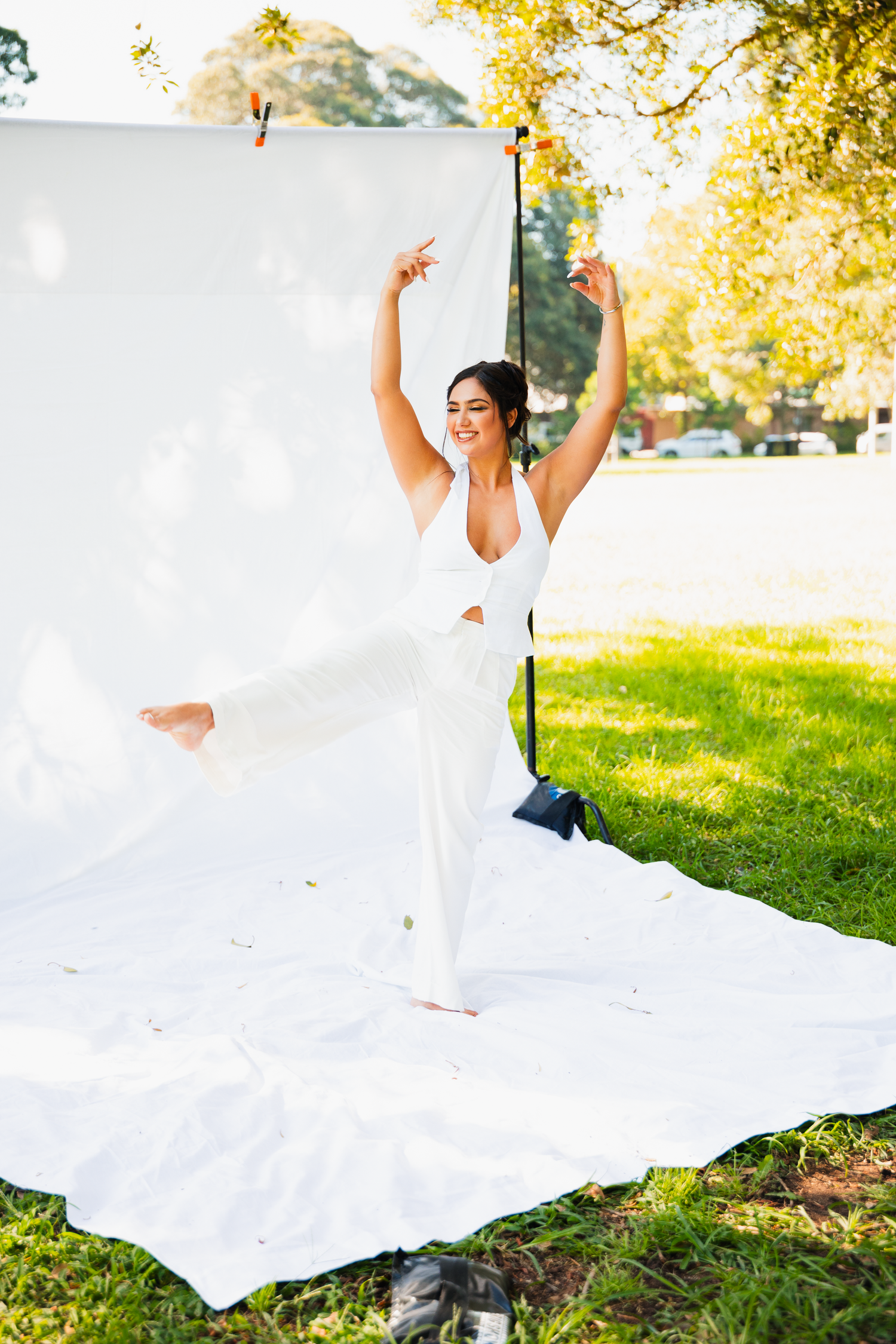 A model posing on a White fabric backdrop for social content. Risque Films Sydney boudoir cinematic photo and video shoot