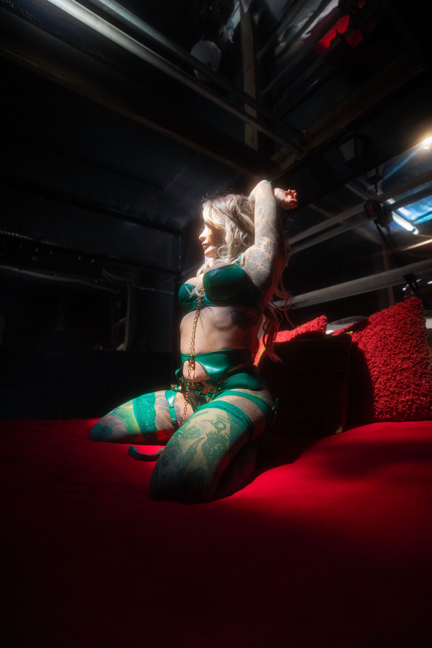 Lingerie model sitting upright for a boudoir photo in green lingerie