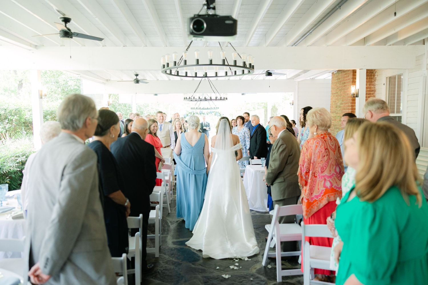 Mother walks daughter and bride down the wedding aisle