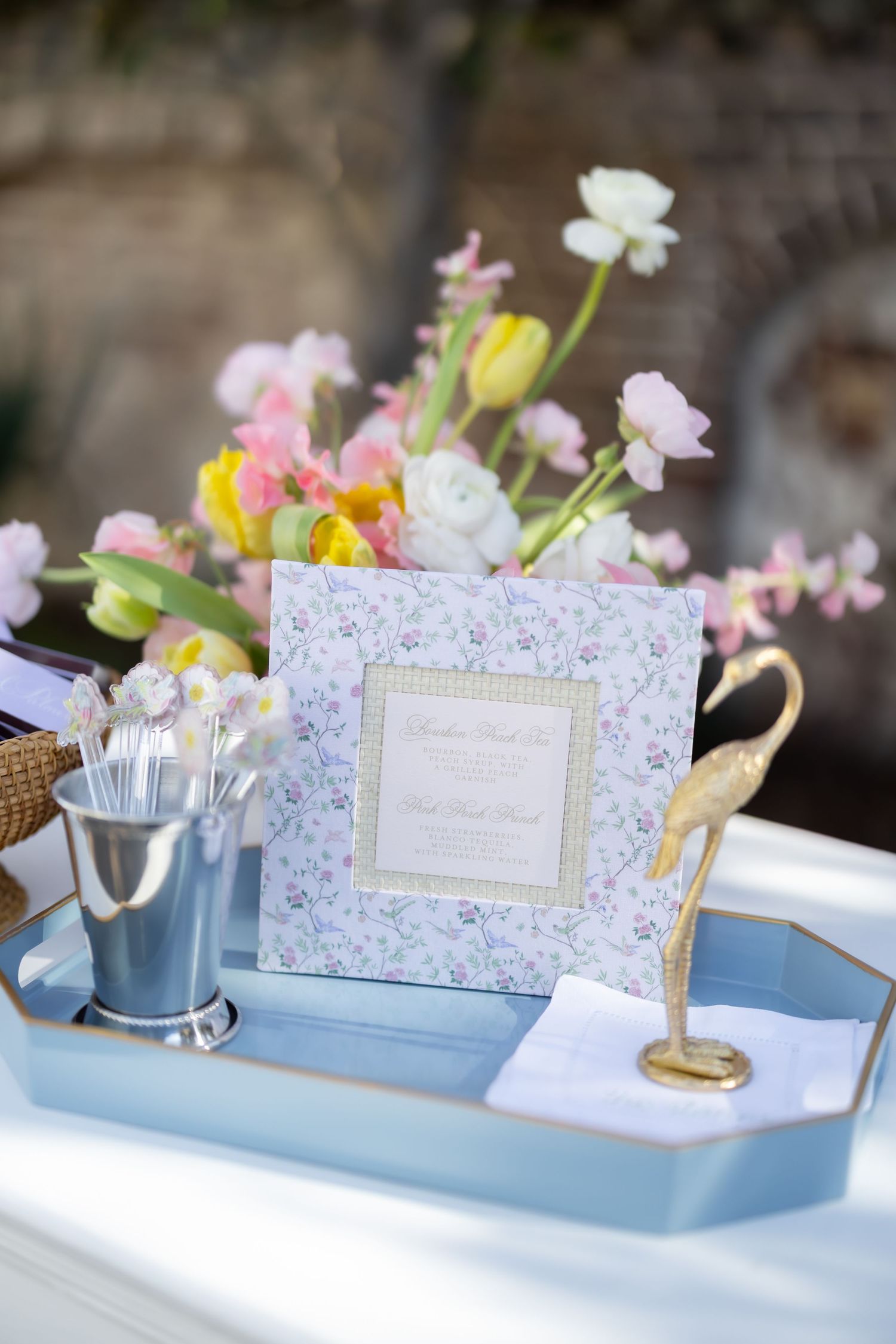 Wedding reception details with floral patterns and blue accents on a decorated table.