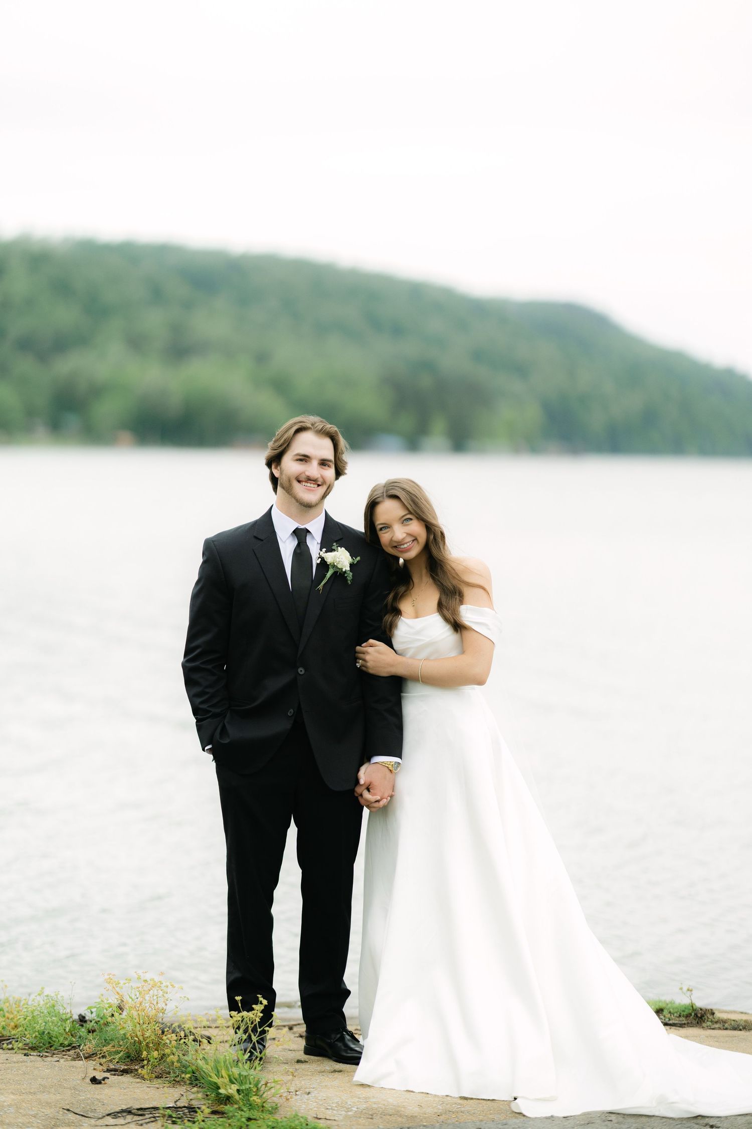 Bride and groom portrait with lake in background