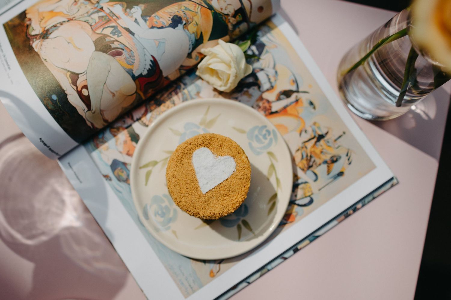 Artistically plated desserts on decorative china plates with delicate garnishes.