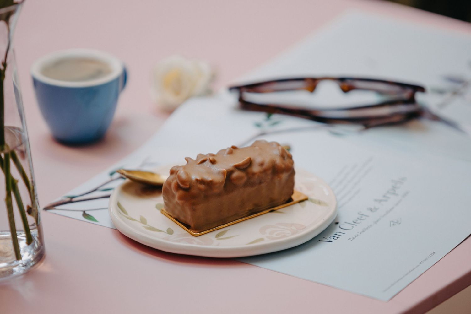 Pastries and desserts elegantly plated on white china with delicate designs.