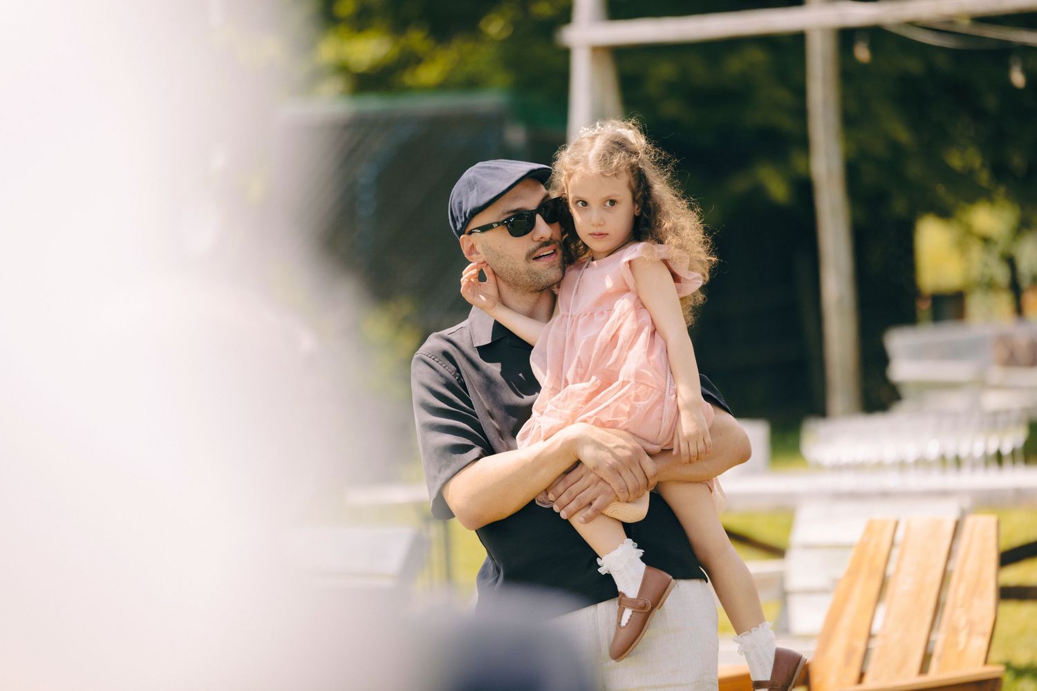 A tender moment captured at an outdoor wedding celebration.