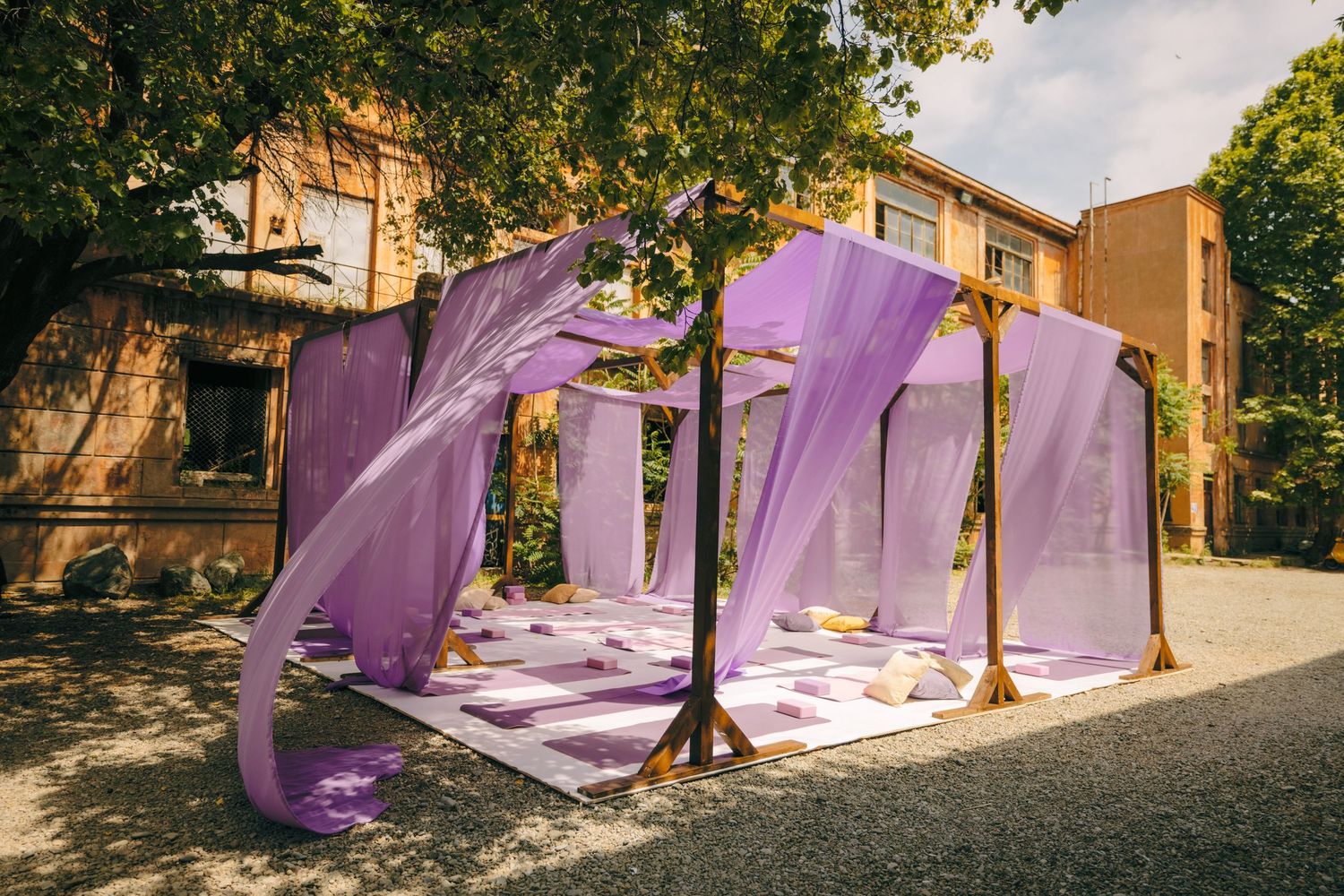 Purple tent structures lined up outdoors for a tech event.