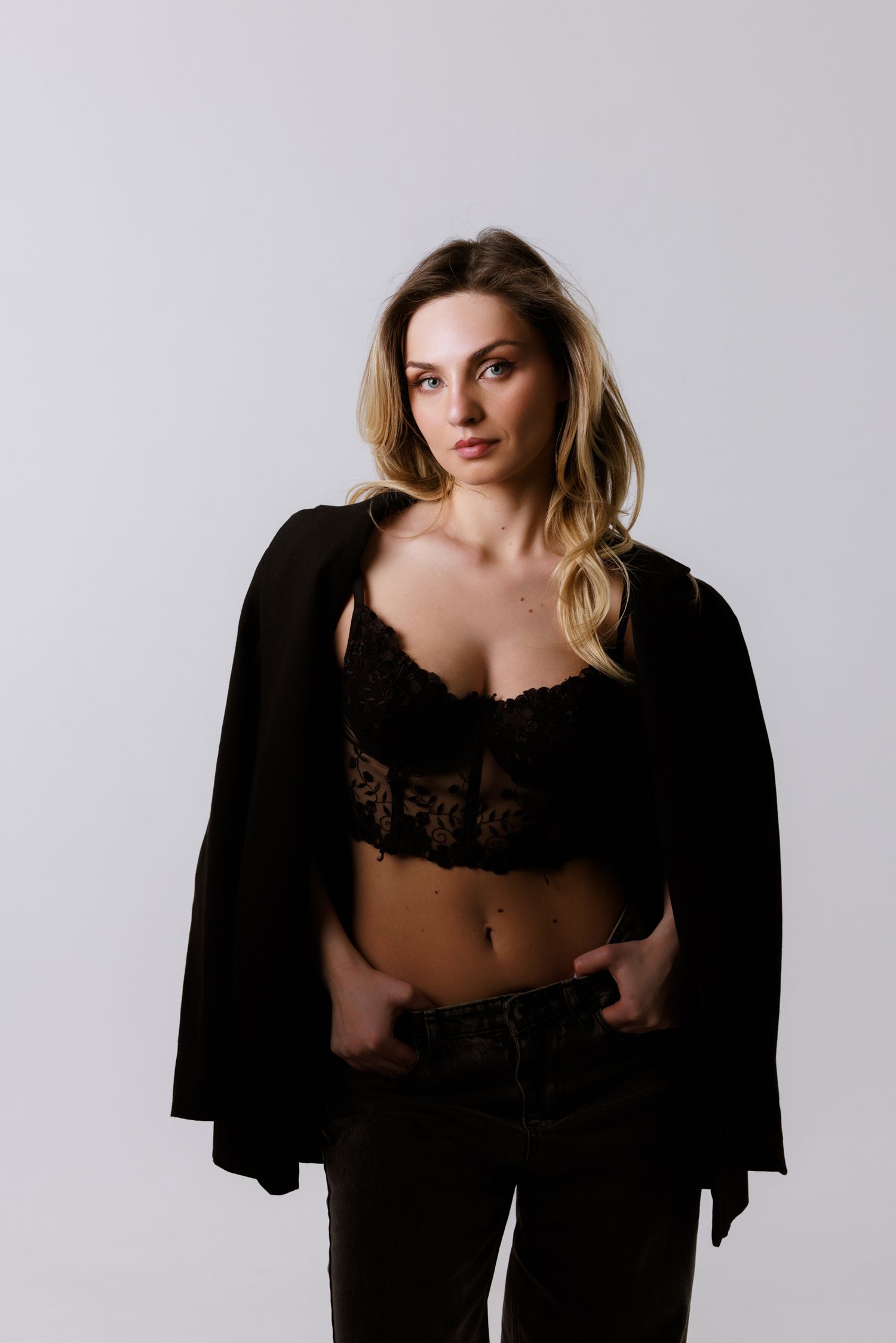Artistic fashion portraits showing model in black clothing against white background.