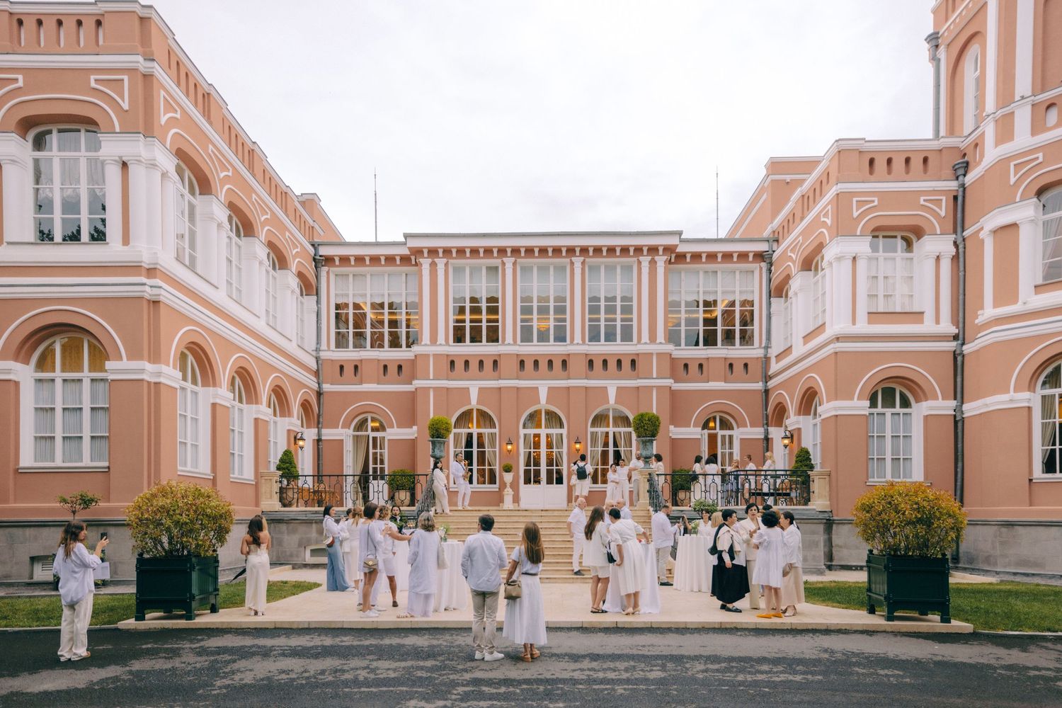 Elegant peach-colored historic building facade with arched windows and classical architecture details.