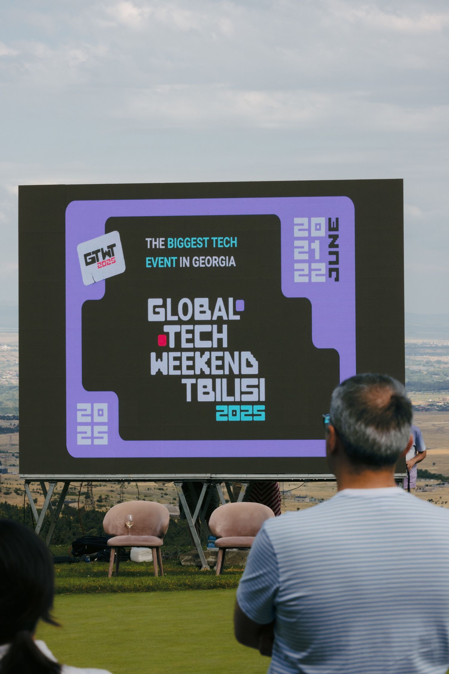 Digital displays showing Global Tbilisi Tech Weekend event branding outdoors.