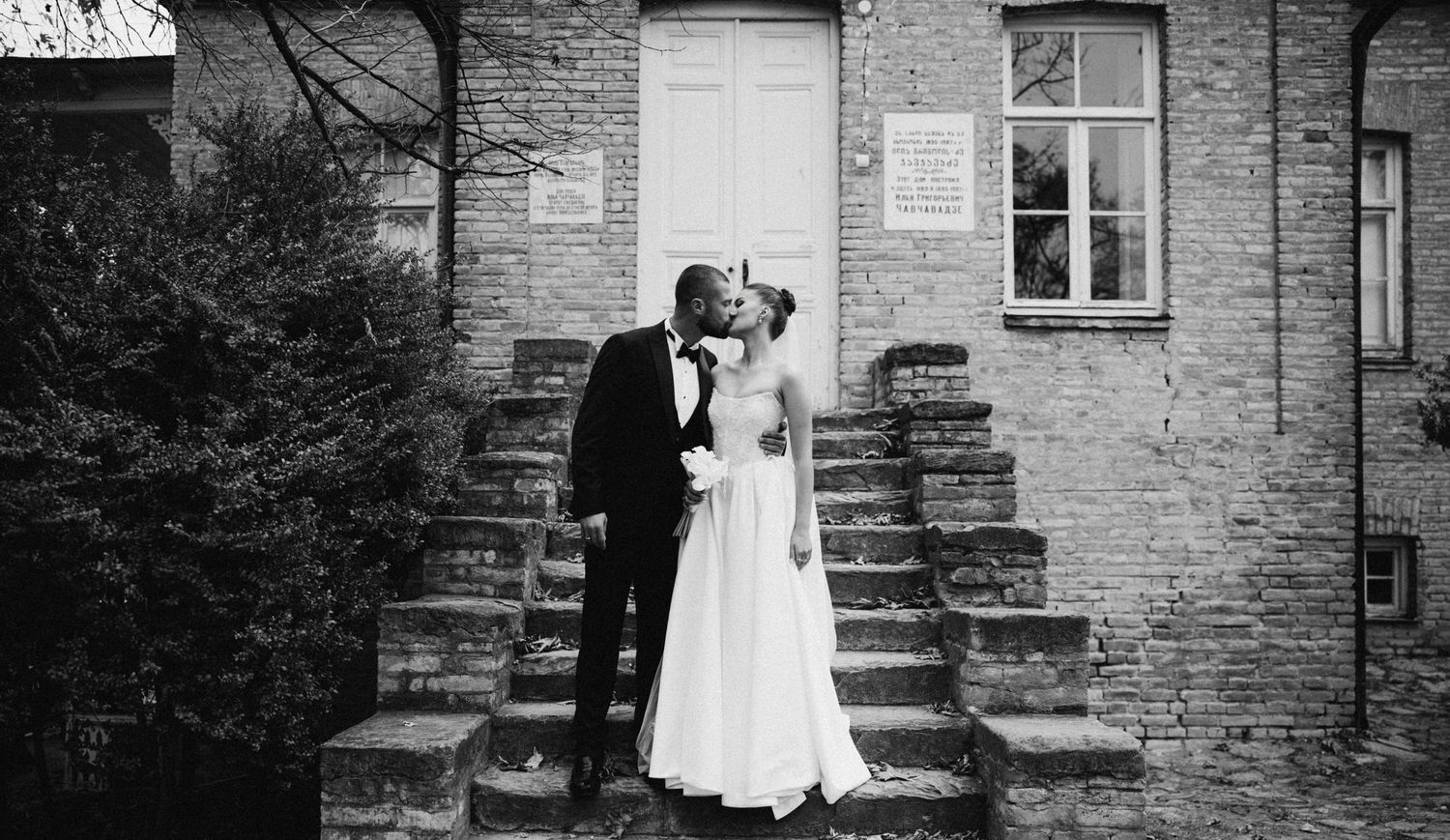 Black and white wedding photos showing couples posing on stone steps of a historic building.