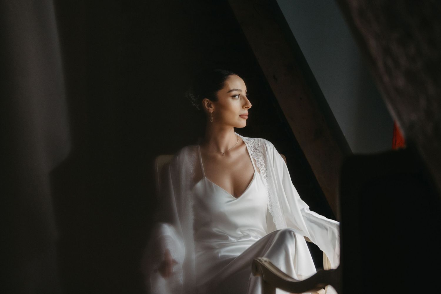 Minimalist portrait series with soft window lighting and white clothing.