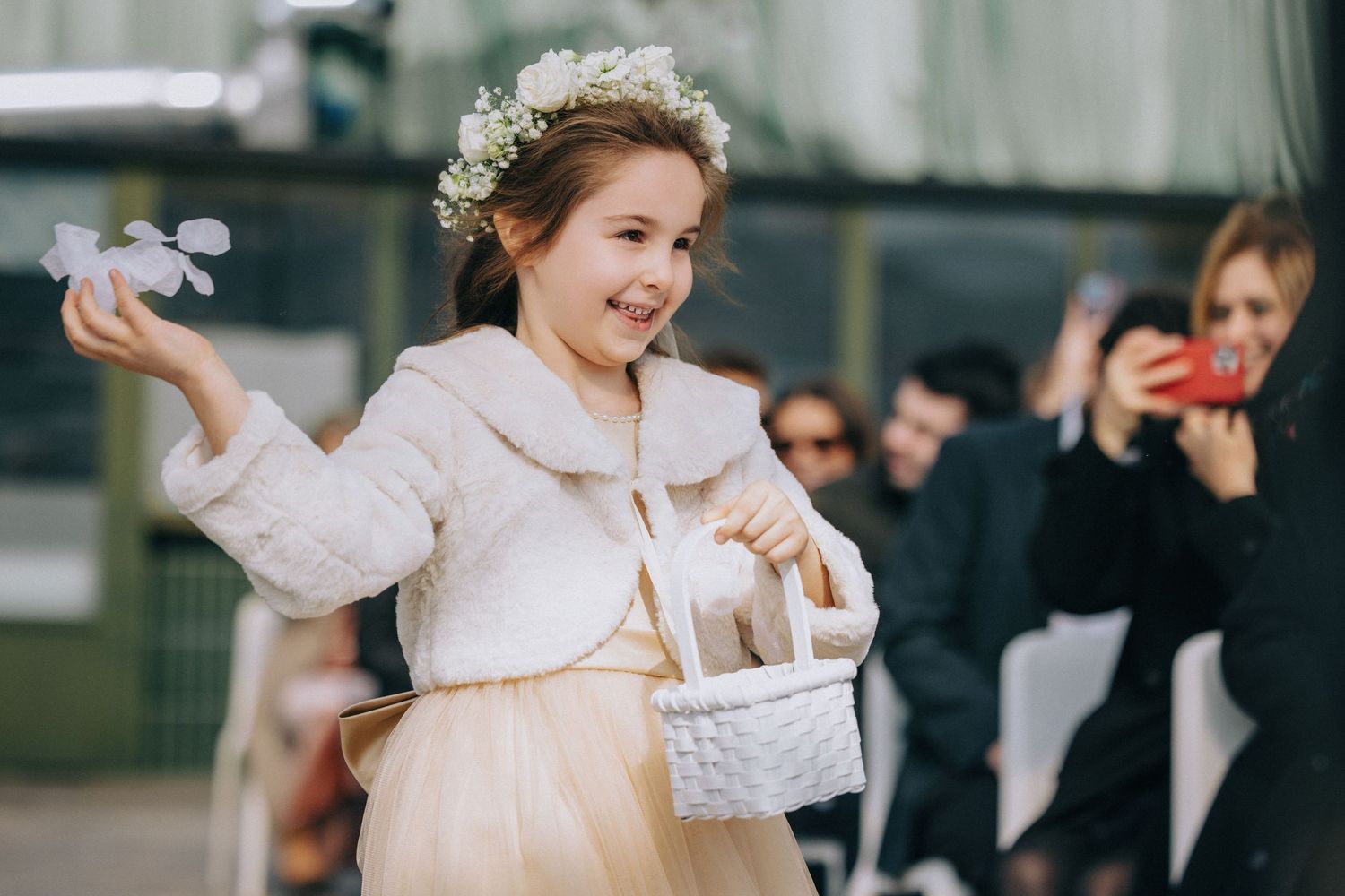 Wedding celebration outdoors with guests and attendees in formal attire.