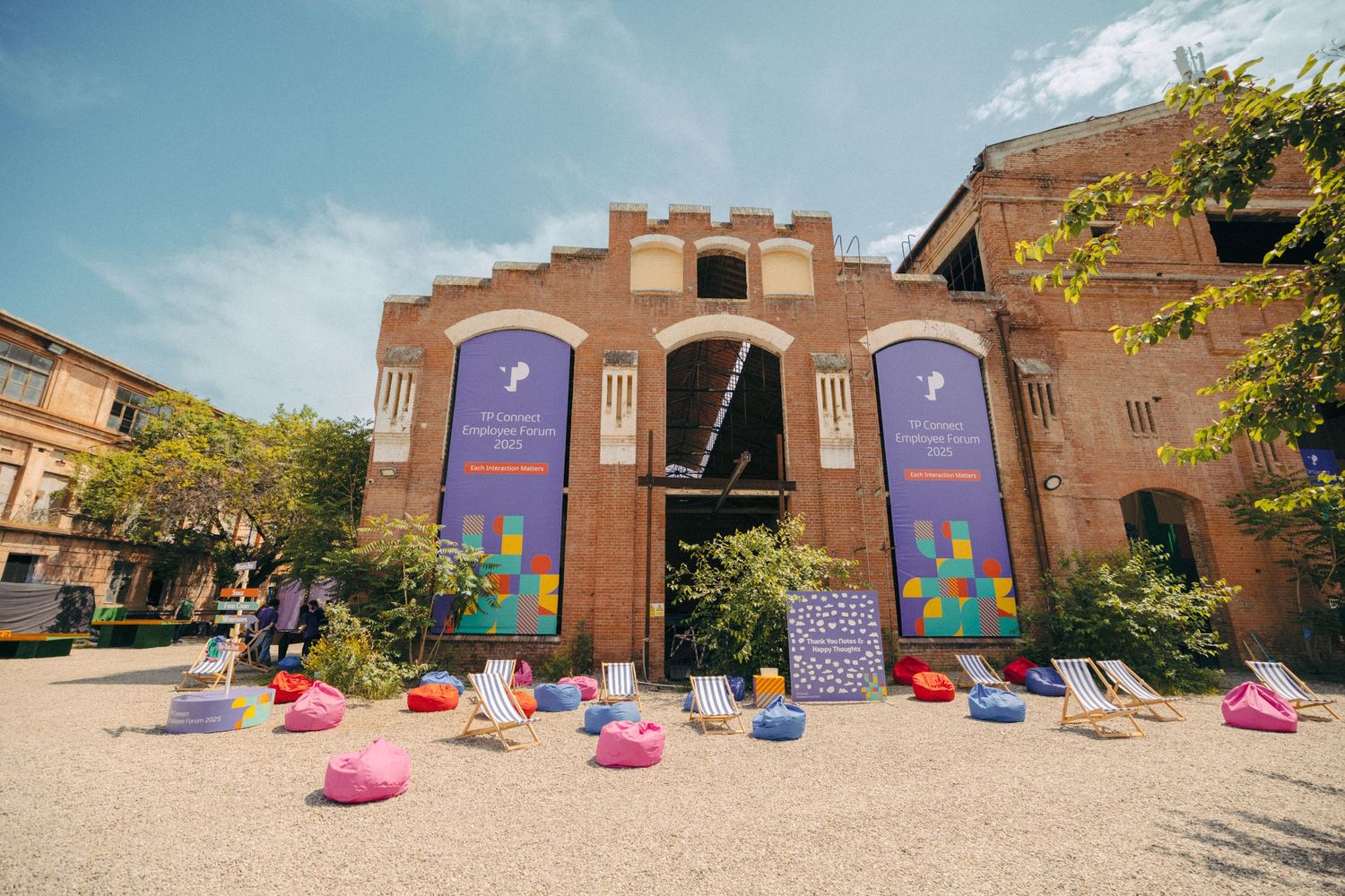 Historic brick building exterior decorated with colorful bean bag seating for an event.