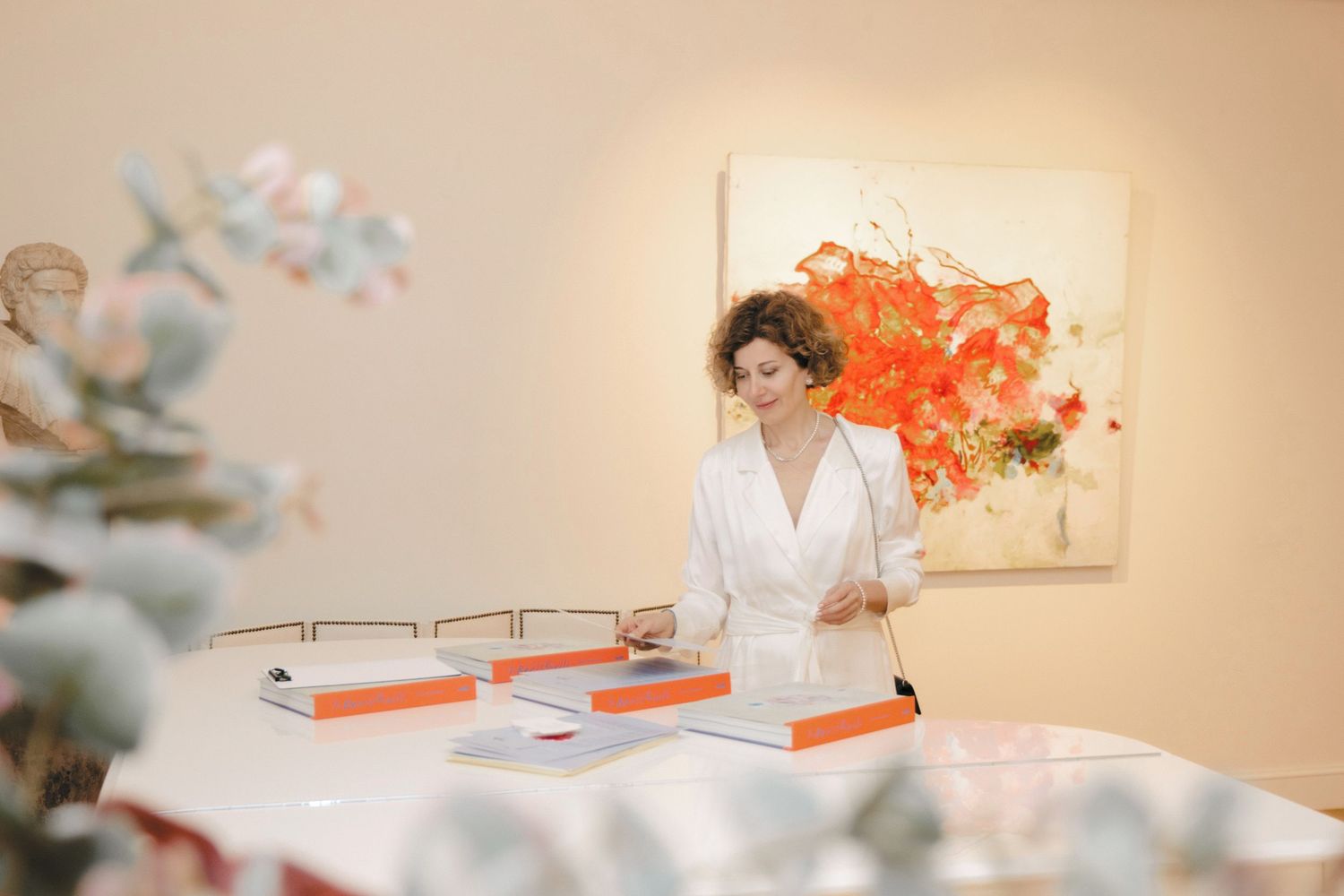 Modern art gallery interior with white walls and abstract paintings.
