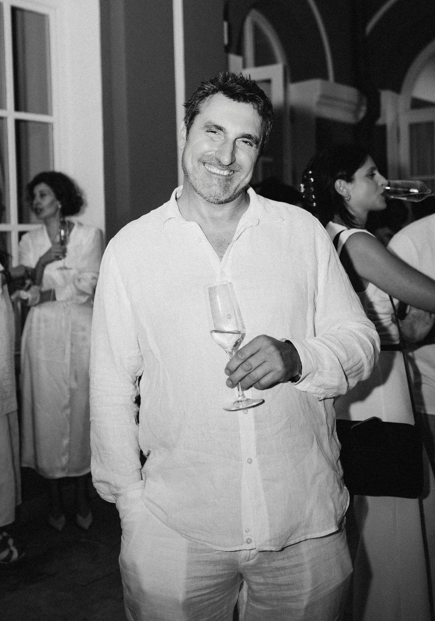 Black and white photo of guests in formal attire at an elegant event.