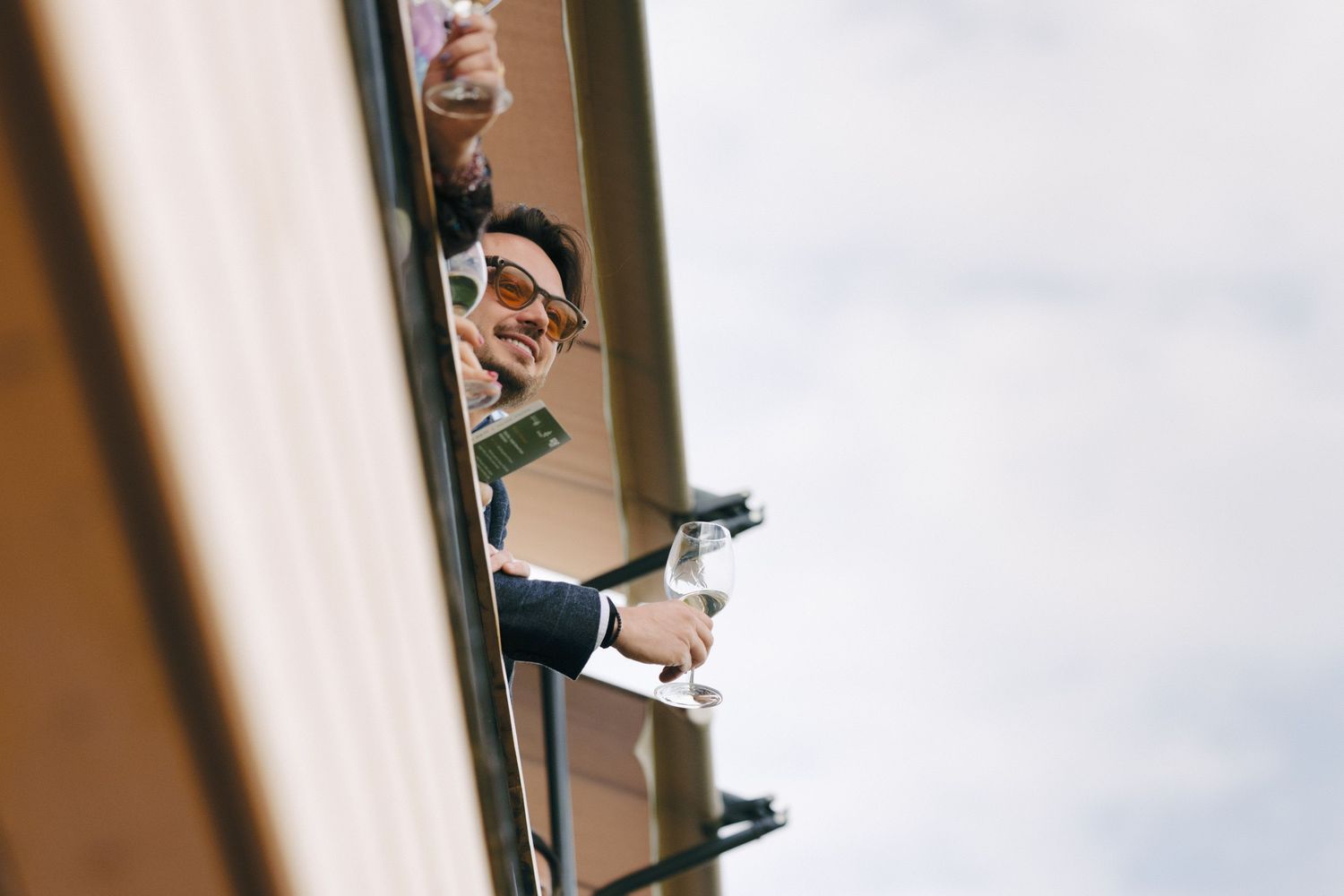 View through window frames of guests at an outdoor event.