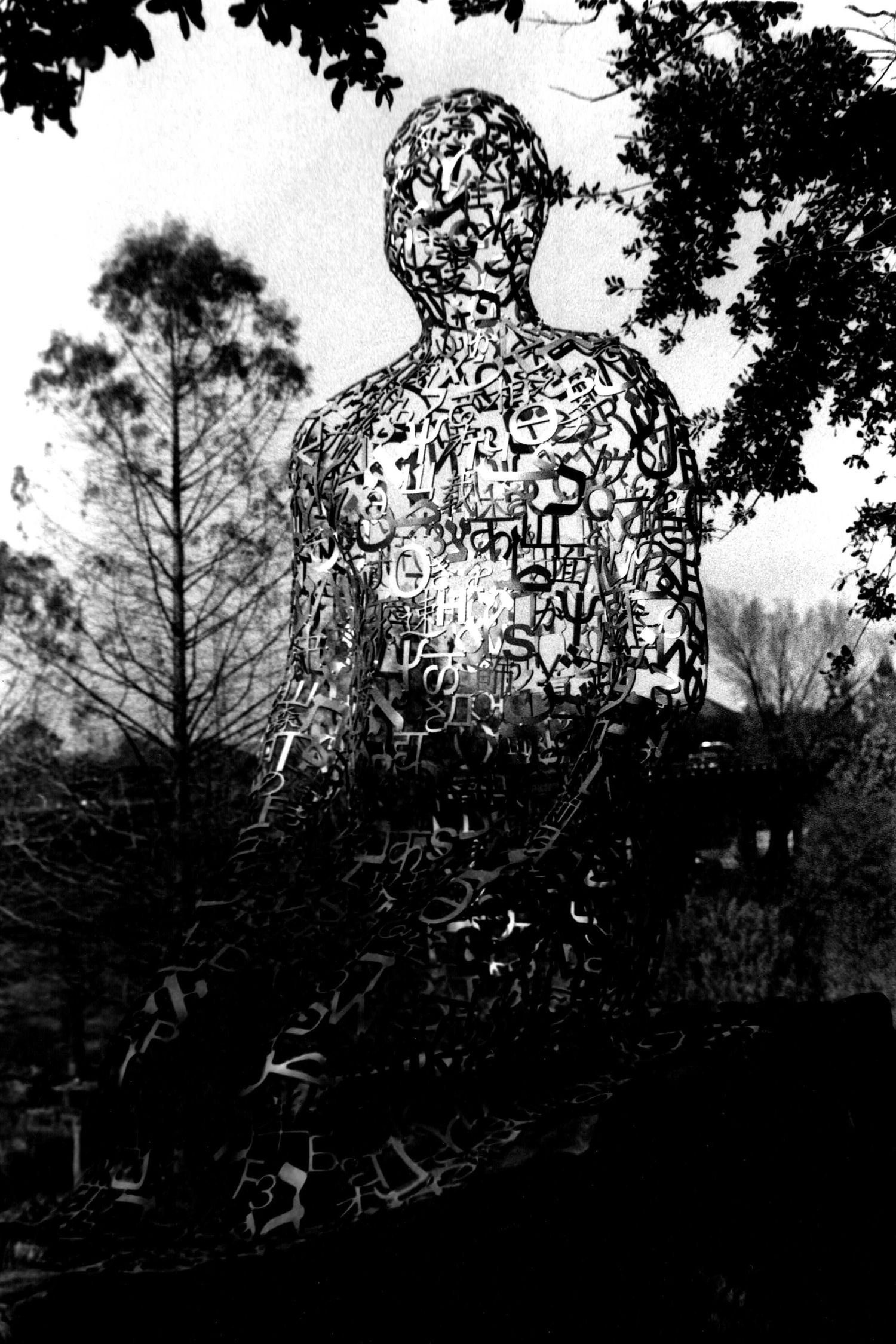 Houston's iconic Tolerance Statue with silhouetted trees in the background.