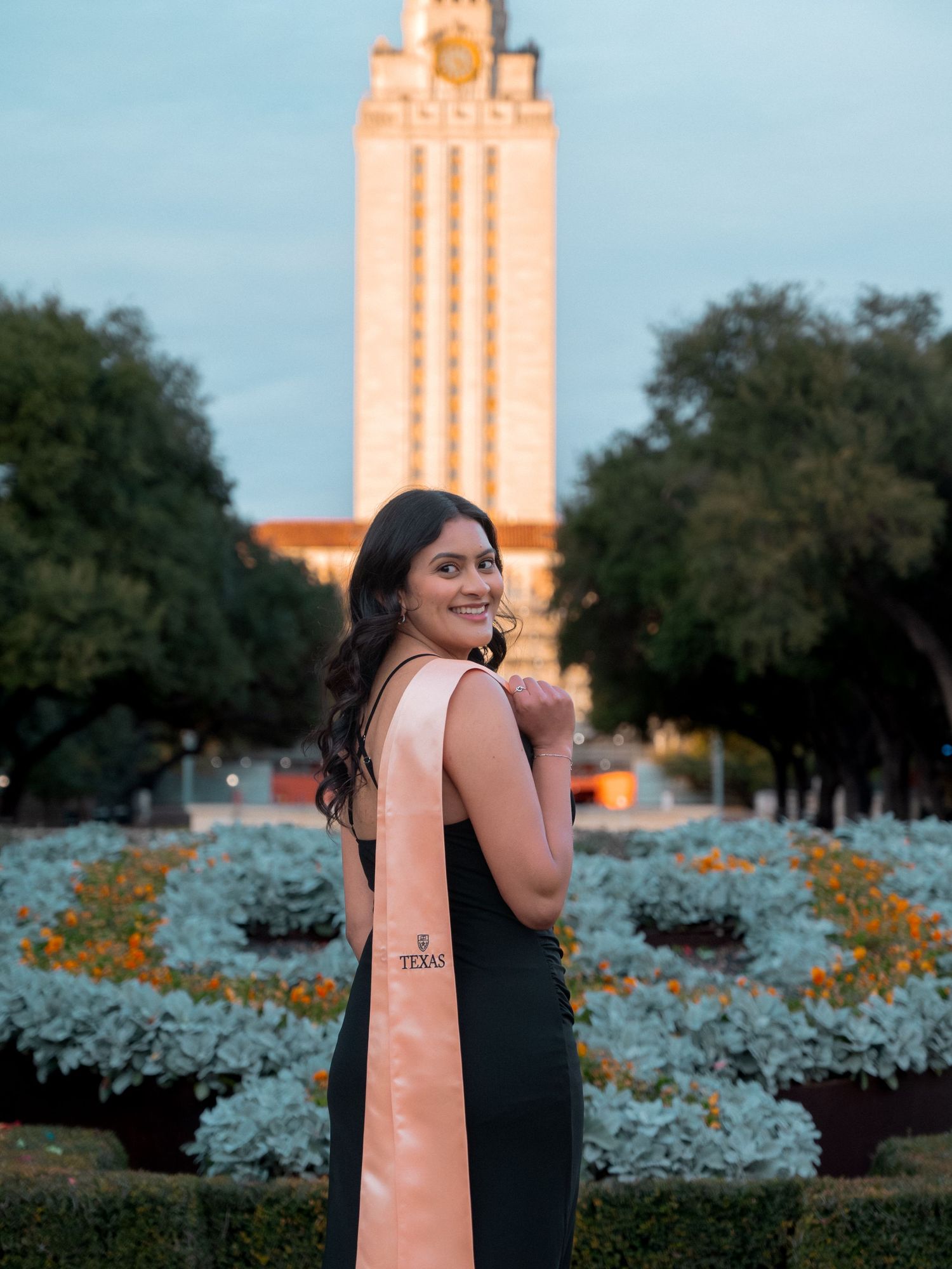 A series of photos showing someone posing in front of the iconic UT Austin Tower with bluebonnets blooming in the foreground.