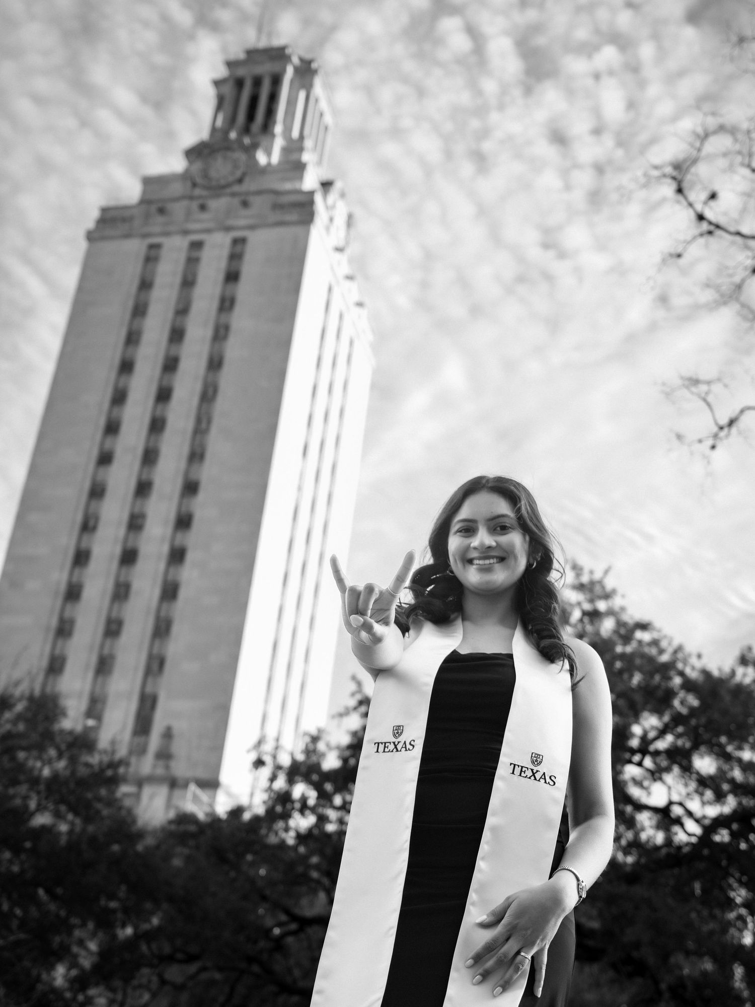 A series of black and white photos showing a person posing near the iconic University of Texas Tower on campus.